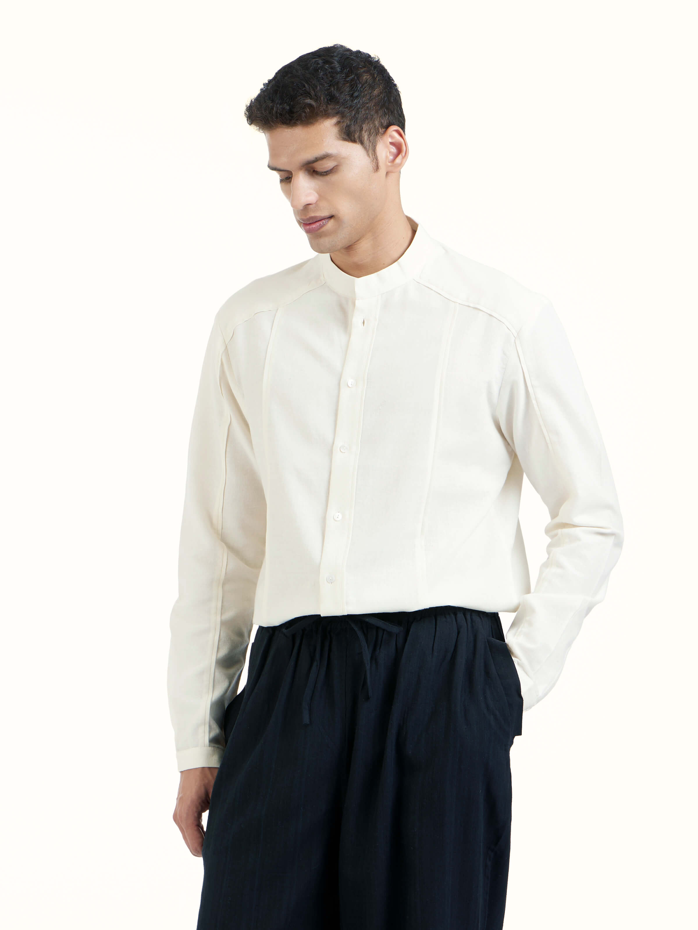 Angled view of black silk handloom straight pants highlighting fabric sheen and structure