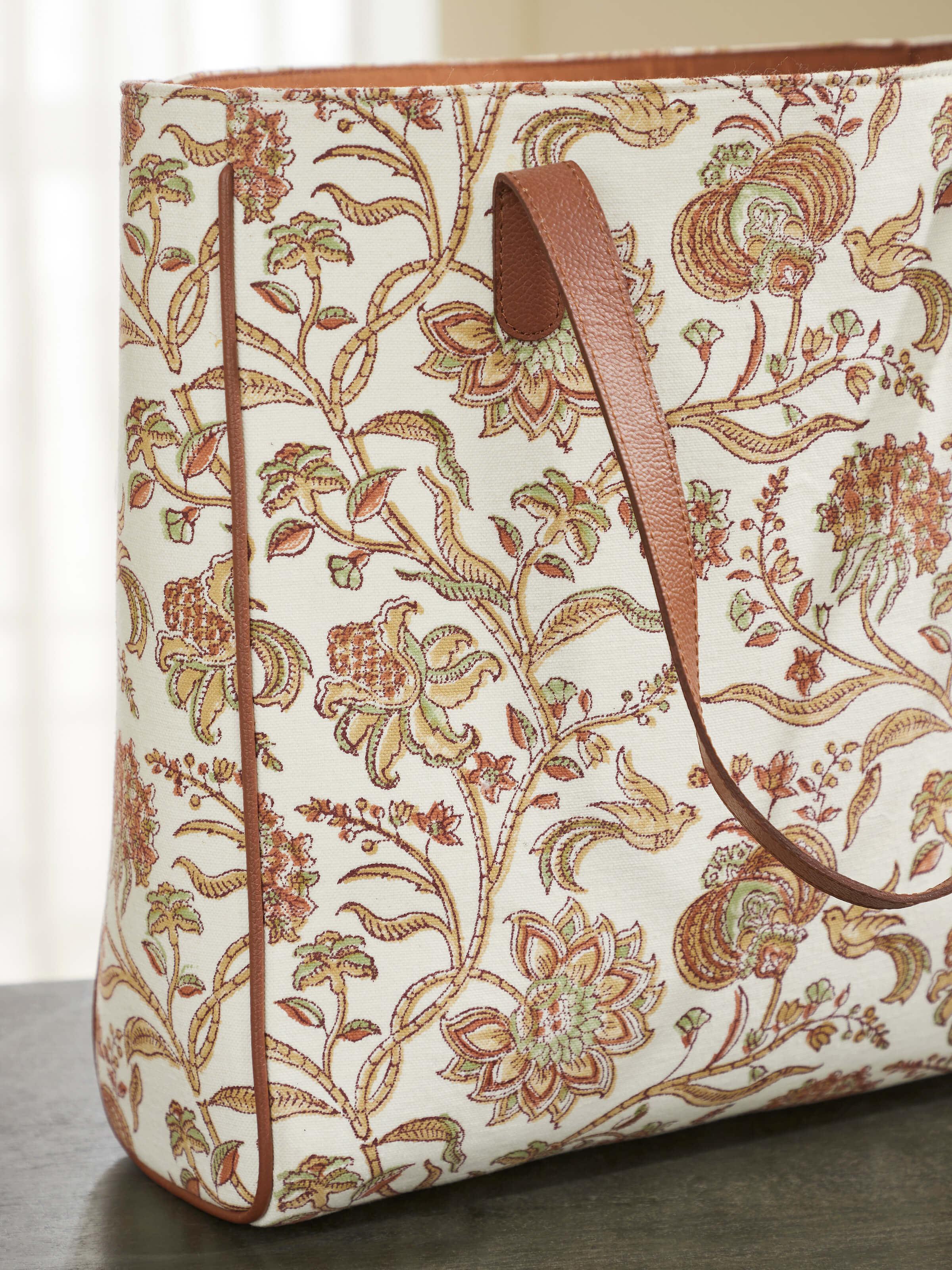 Angled view of Leather & Textile Hand Block Printed Tote Bag highlighting intricate block print patterns and leather texture.