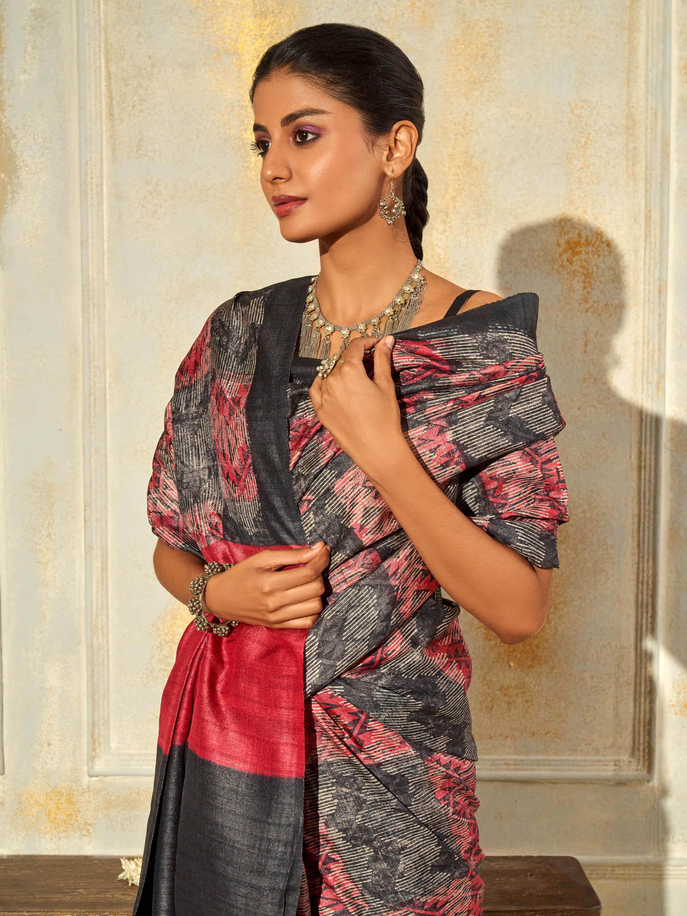 Angled view of black tussar silk discharge block printed saree highlighting block prints