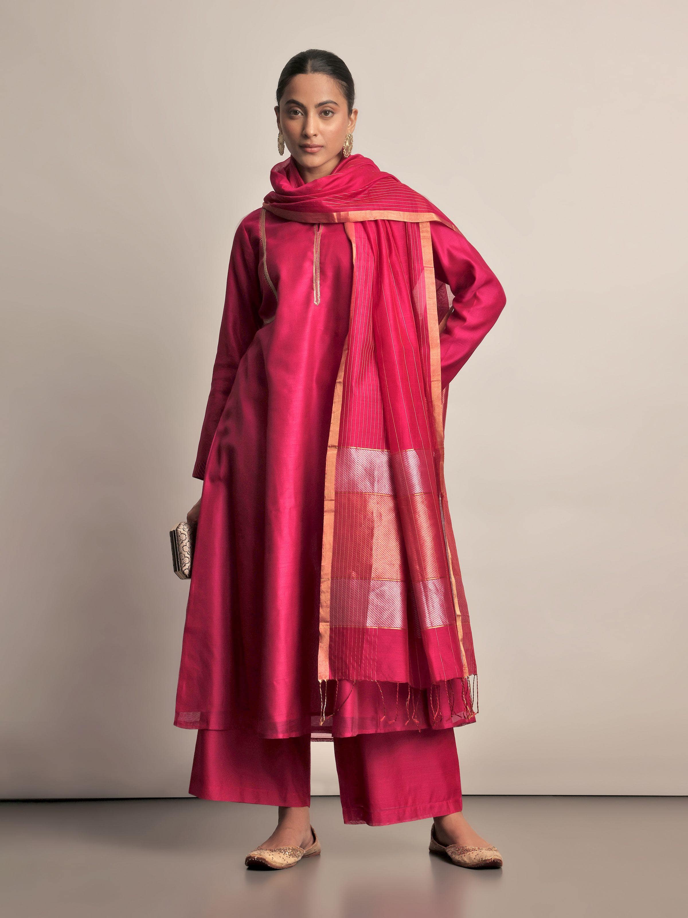 Lifestyle view of fuschia Chanderi palazzo paired with ethnic top in an elegant ensemble