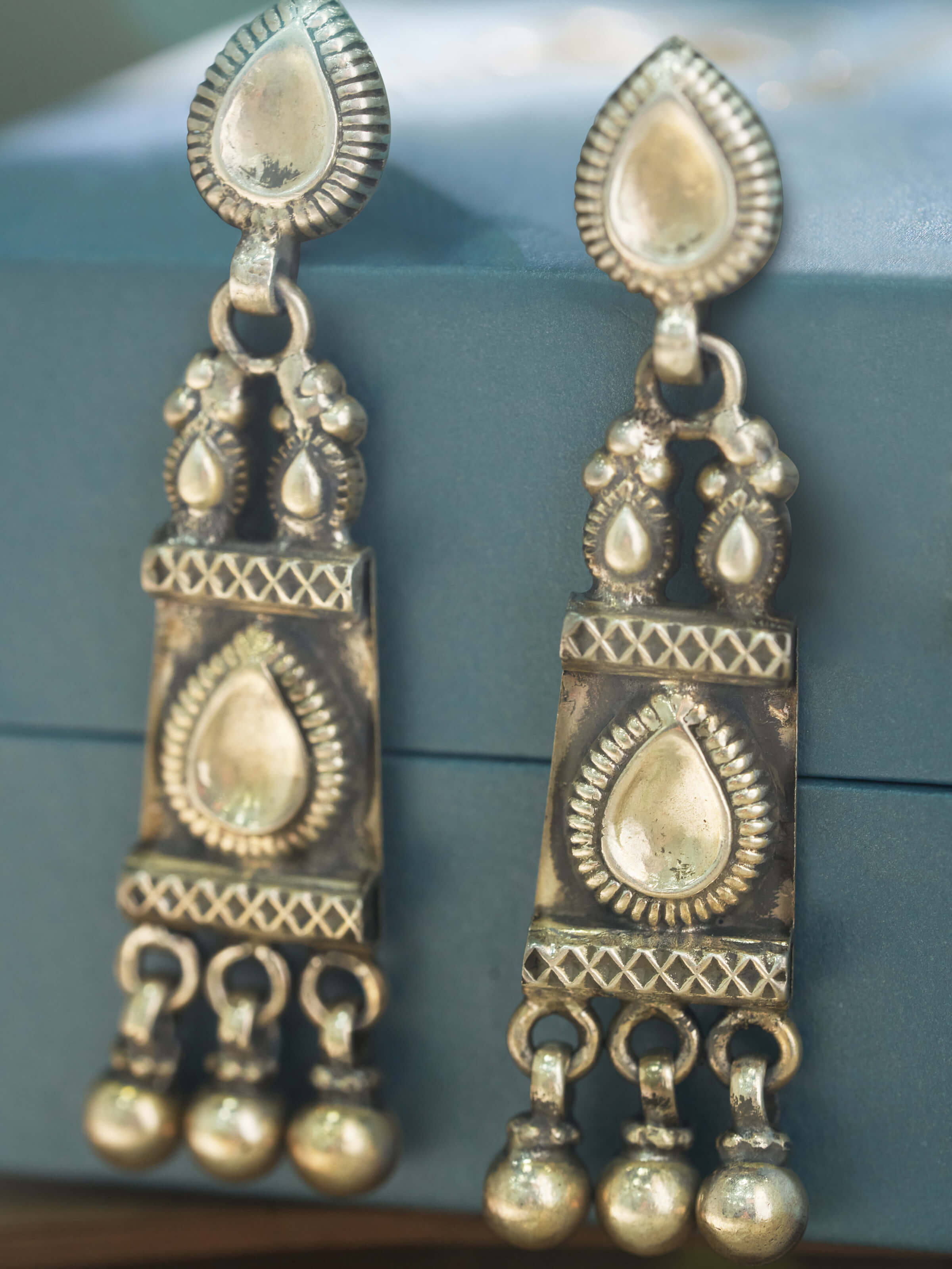 Close-up of Smithing drop earrings showing metalwork details
