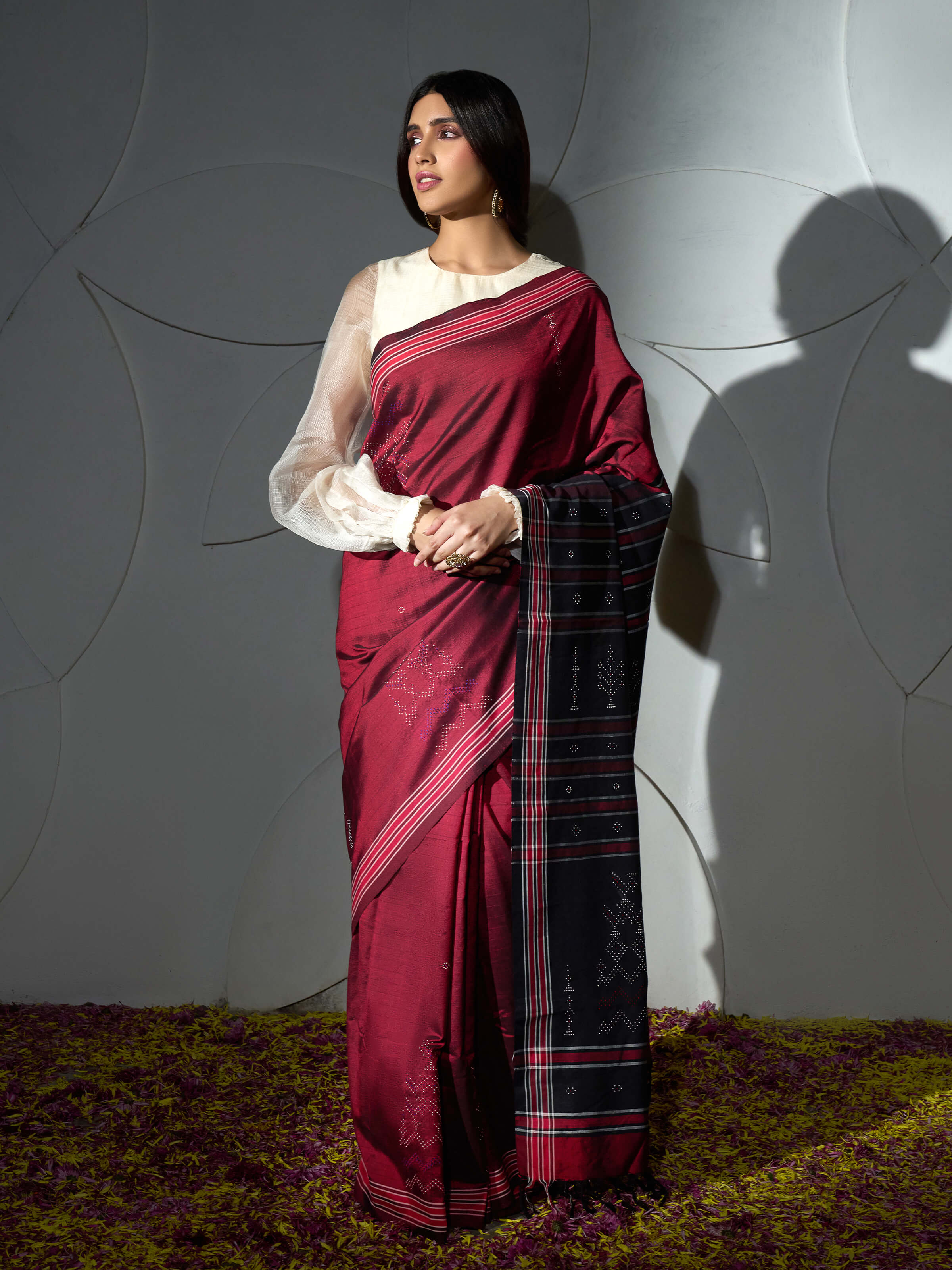 Side view of maroon cotton silk tangalia saree with soft drape and woven border