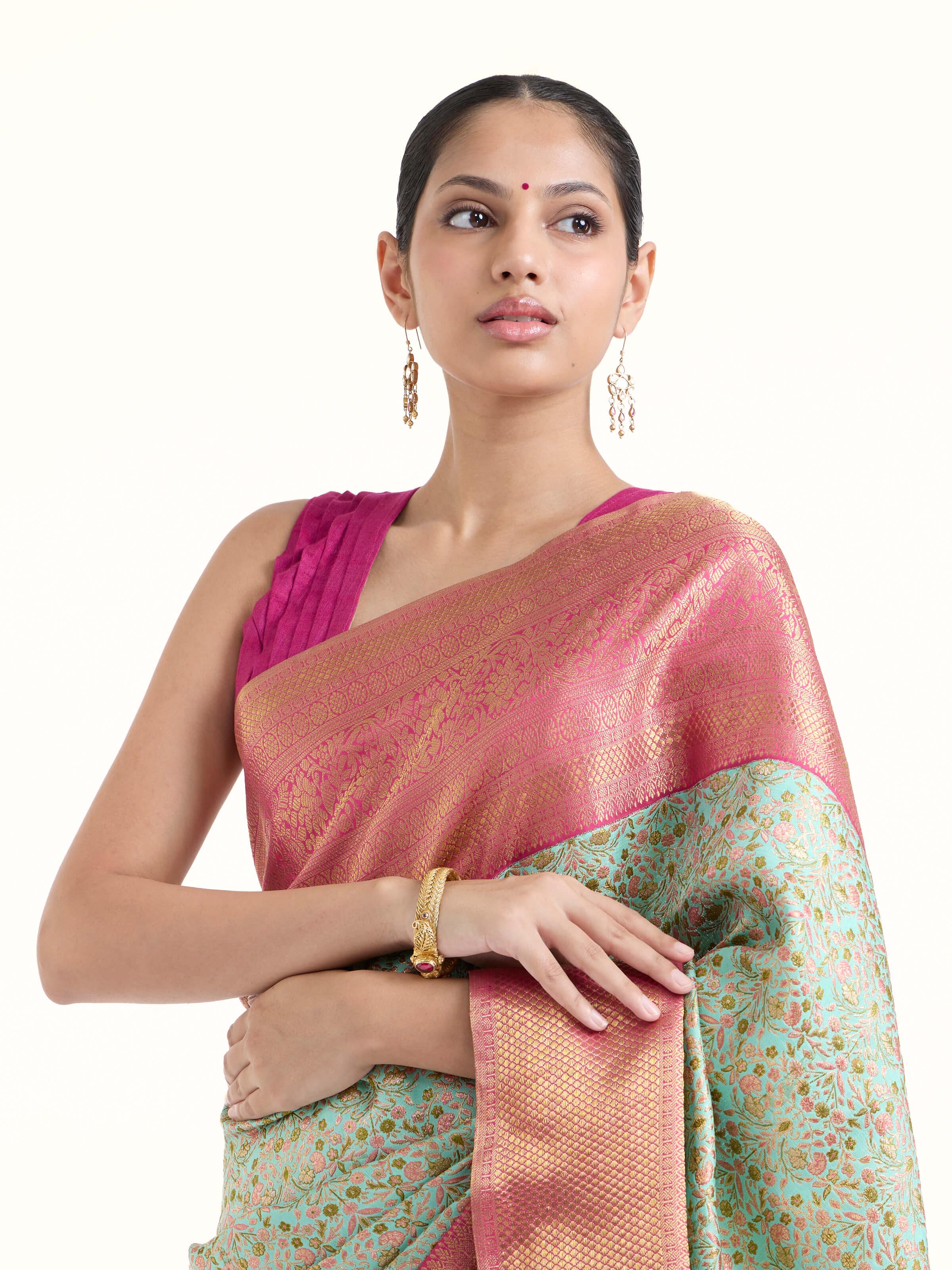 Angled view of sea green silk Kancheepuram saree highlighting intricate zari work