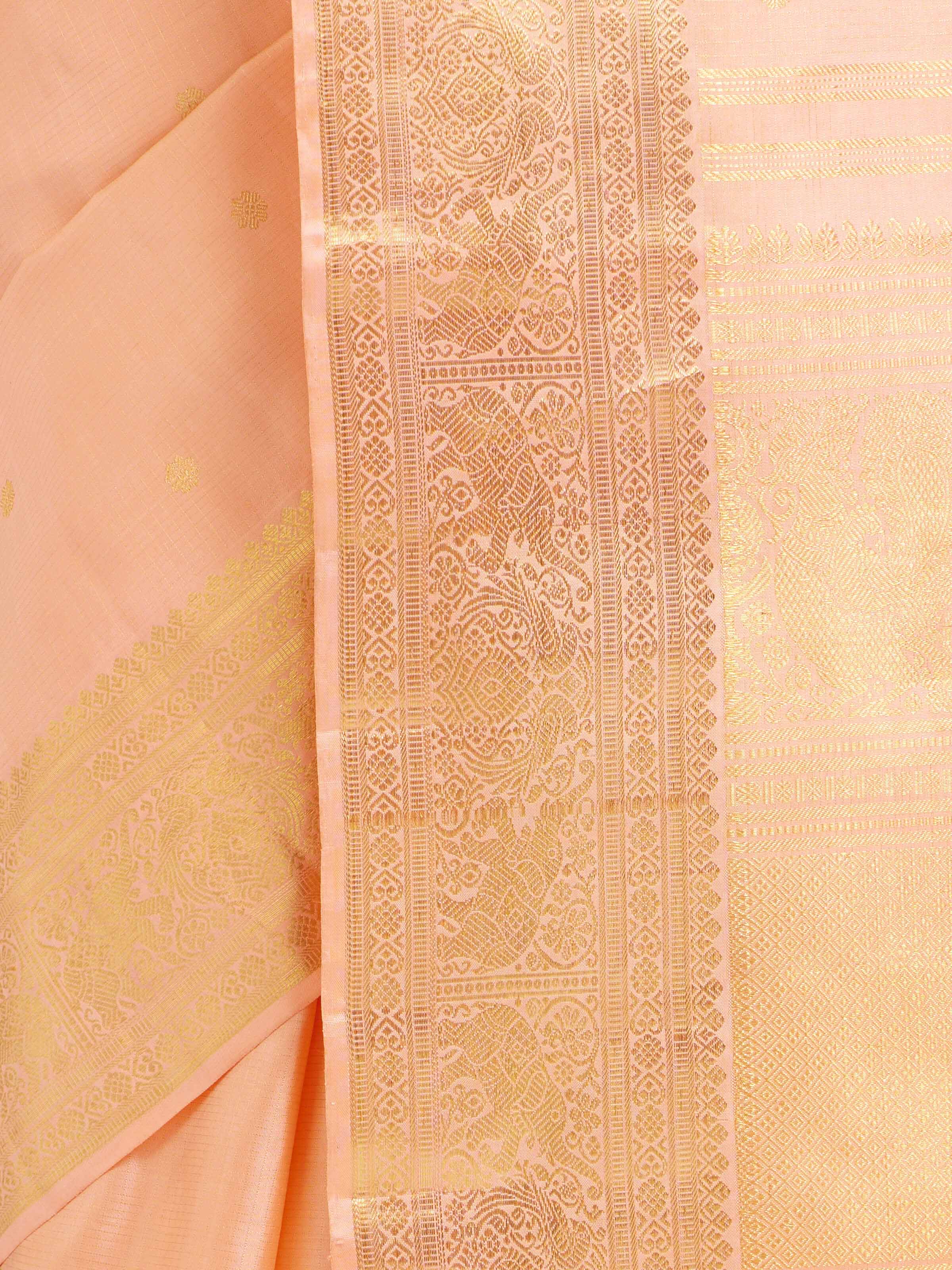Detail view of light pink silk Kancheepuram saree showing silk texture and zari craftsmanship