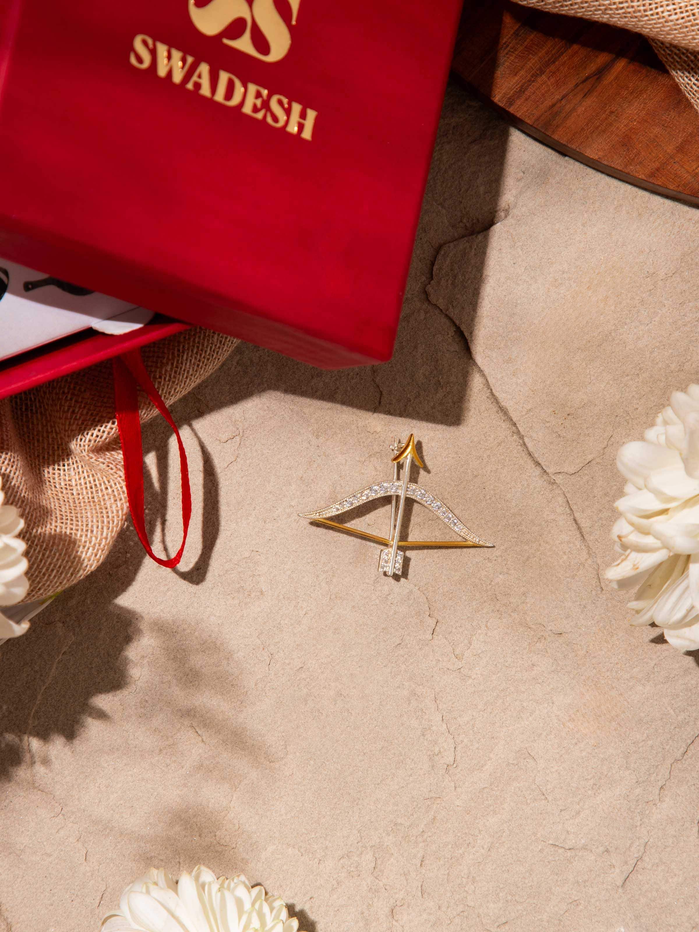 Lifestyle view of silver smithing brooch pinned to a lapel for refined accent