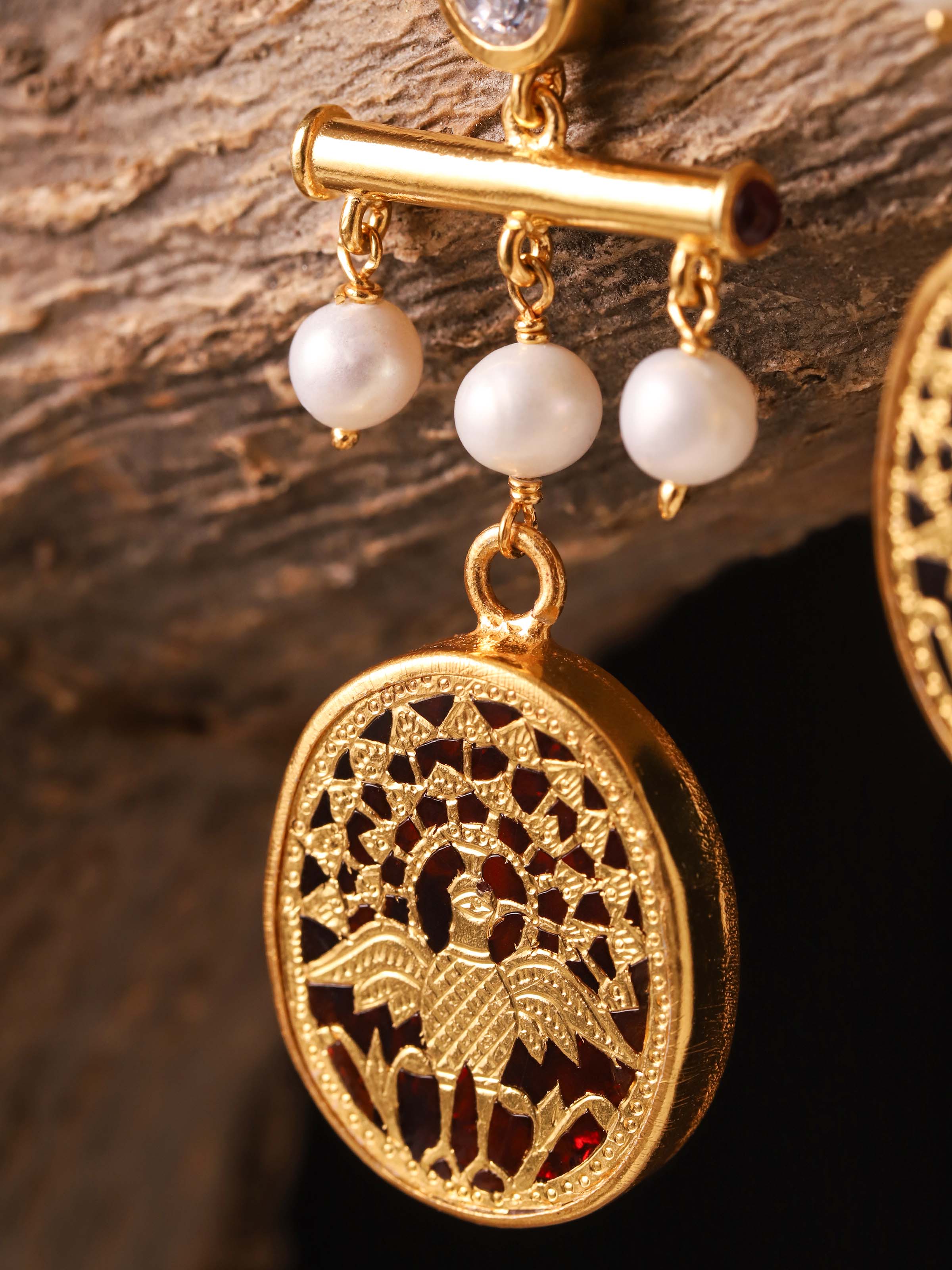 Close-up of Thewa work on silver drop earrings