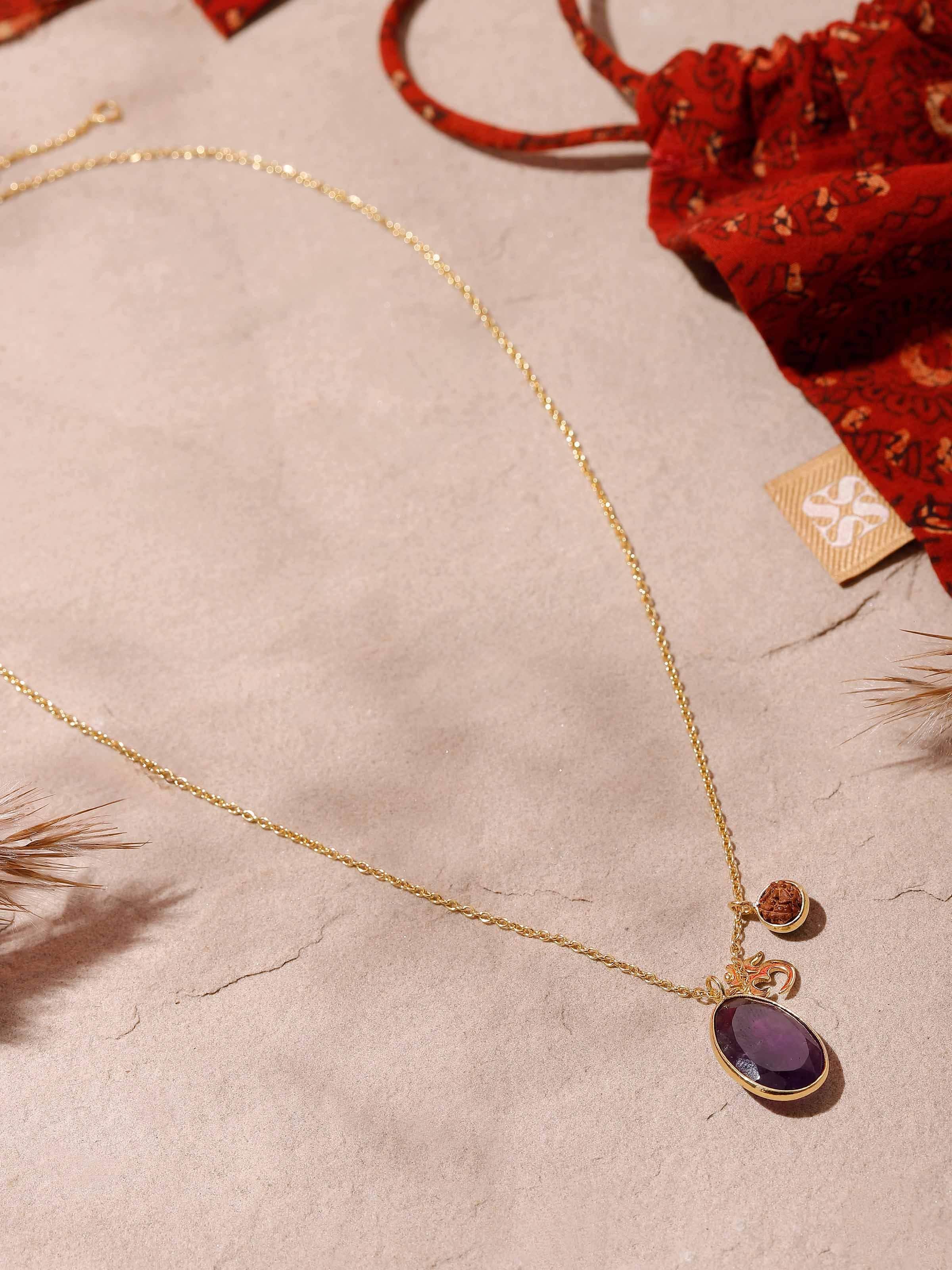 Side view of handcrafted Rudraksha and Amethyst necklace with gold-plated silver Om charm pendant