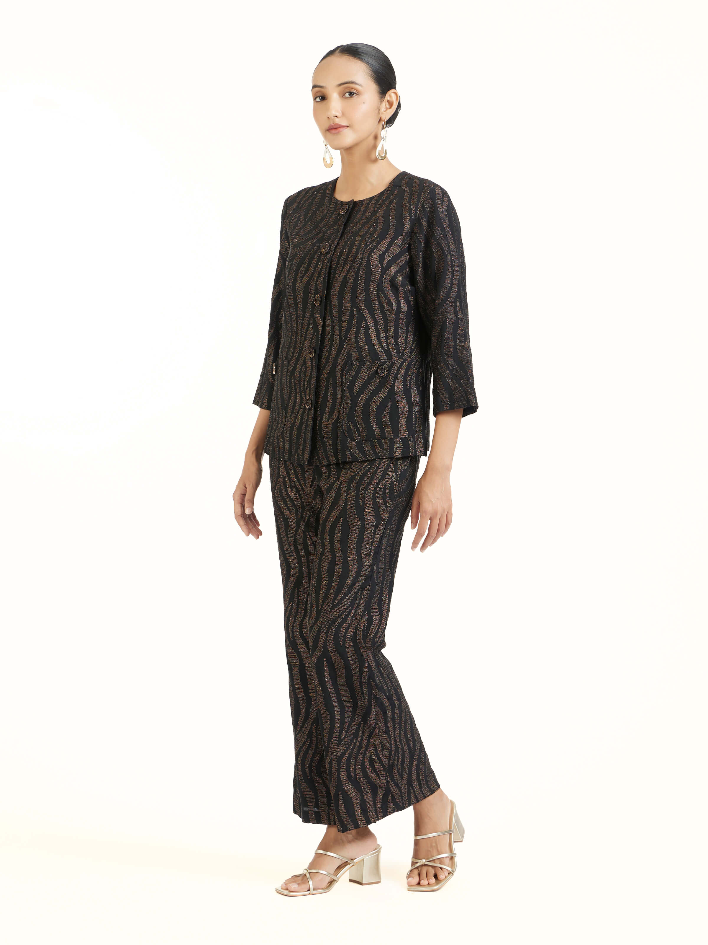 Side view of black Aari hand embroidered pants showcasing tailored fit