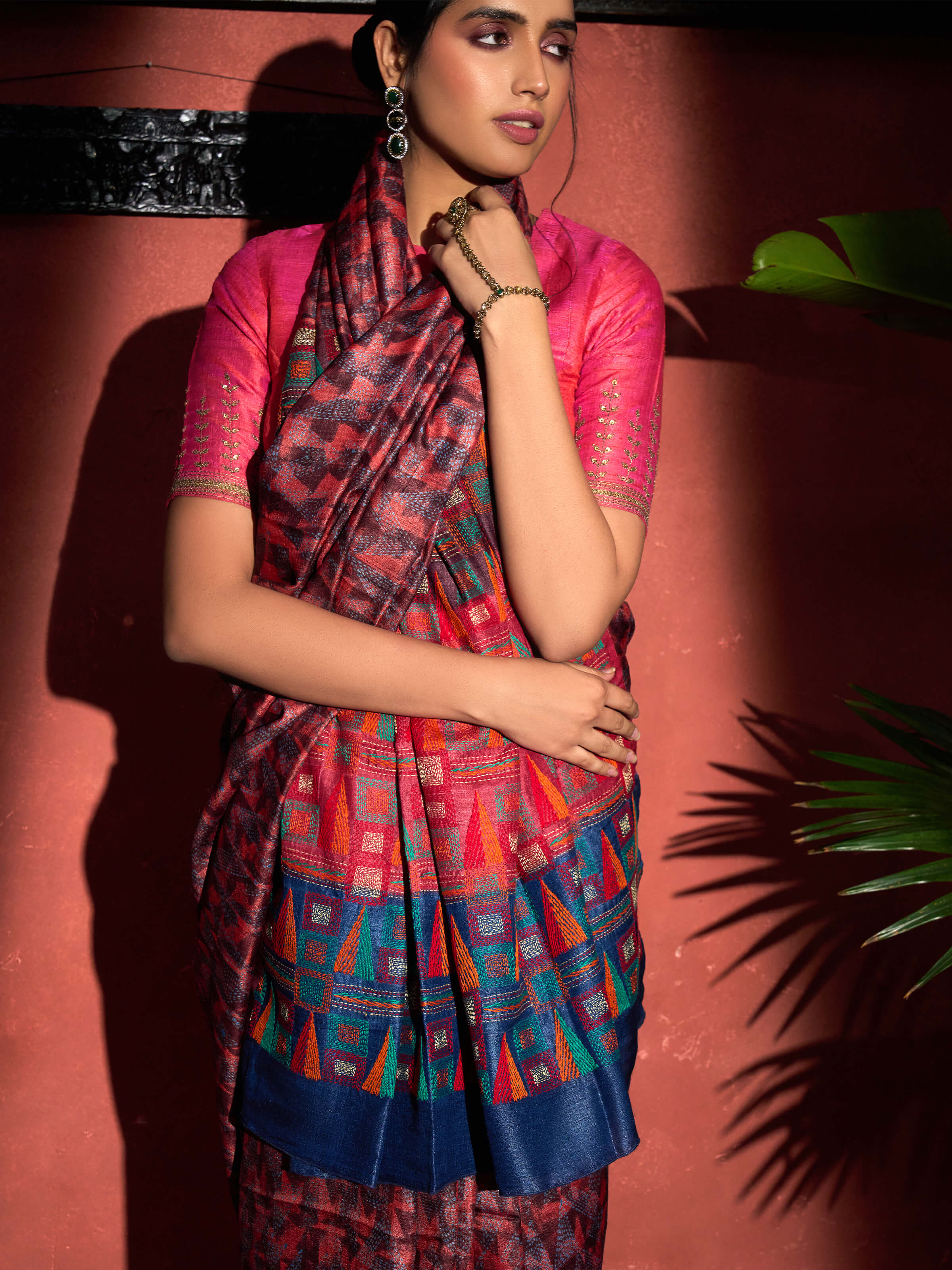 Angled view of red tussar silk discharge printed Kantha embroidered saree showing prints