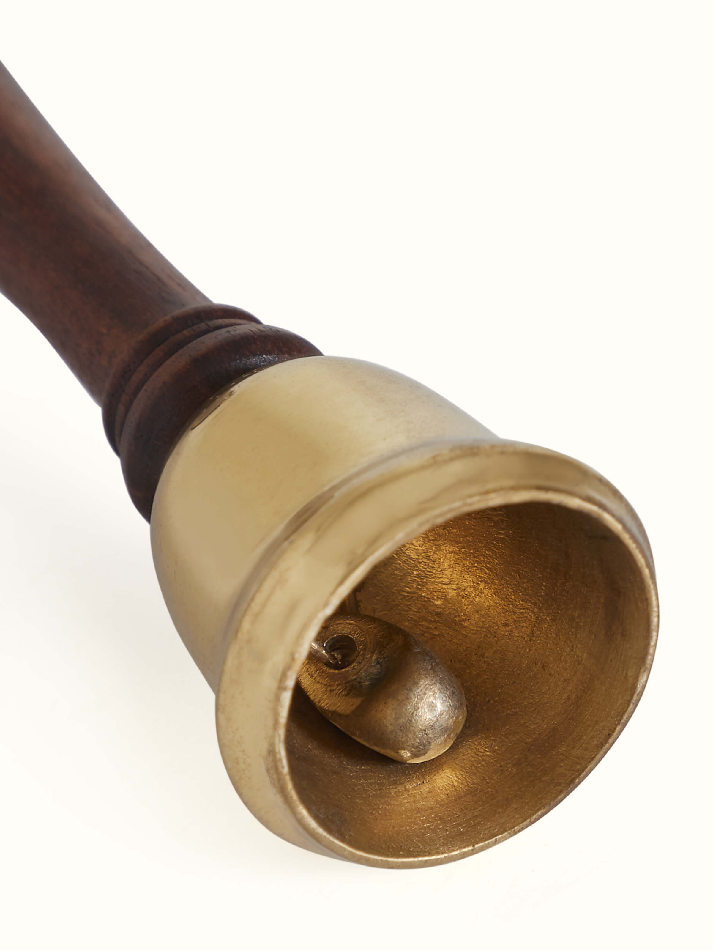 Detail close-up of lacquered brass Thathera pooja bell showing surface finish