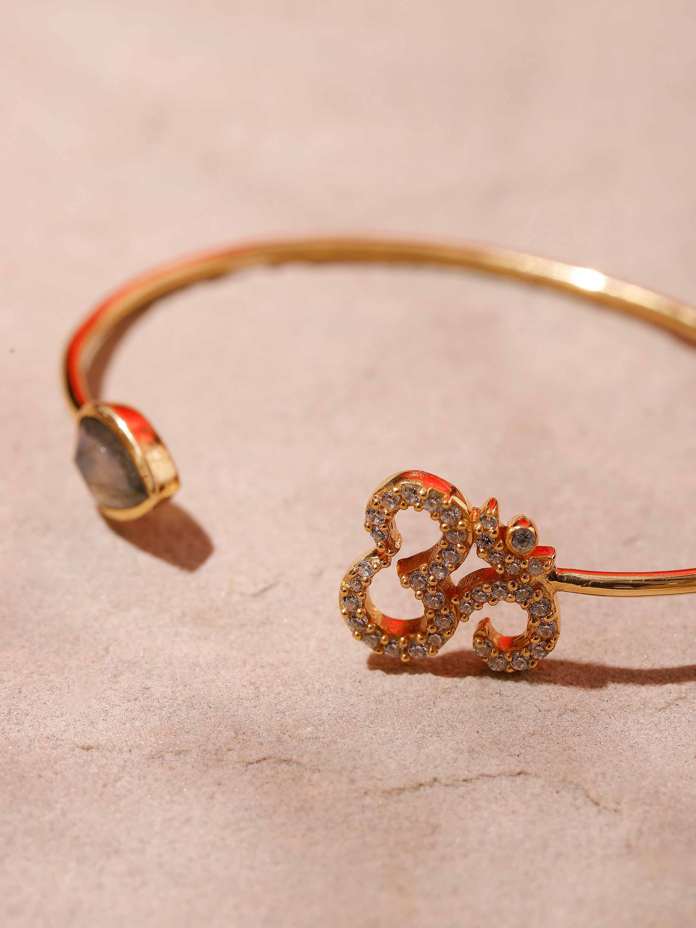Detailed shot of Labradorite & Om Bracelet, focusing on the reflective gemstone and artisanal craftsmanship