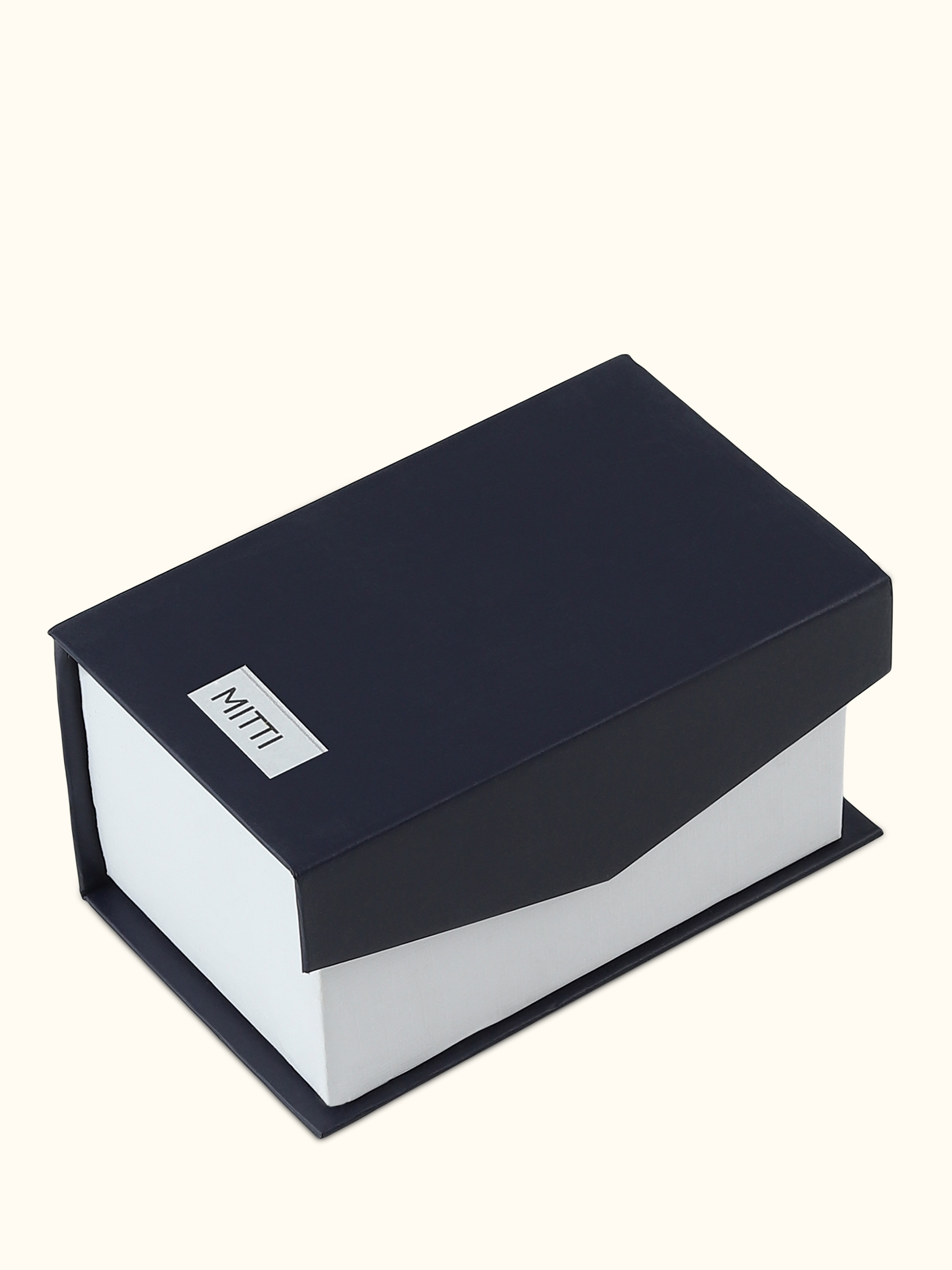 Rear view of Attar Mitti attar bottle focusing on the golden cap and bottle design from behind