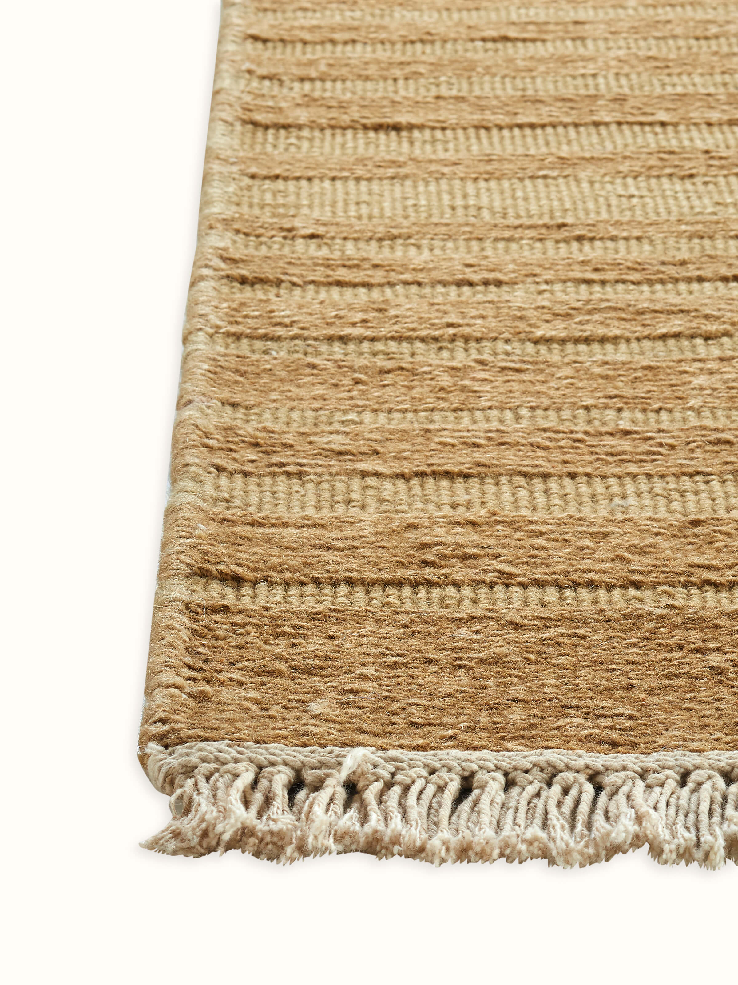 Angled shot highlighting the woven texture and subtle geometric styling of the beige rug.