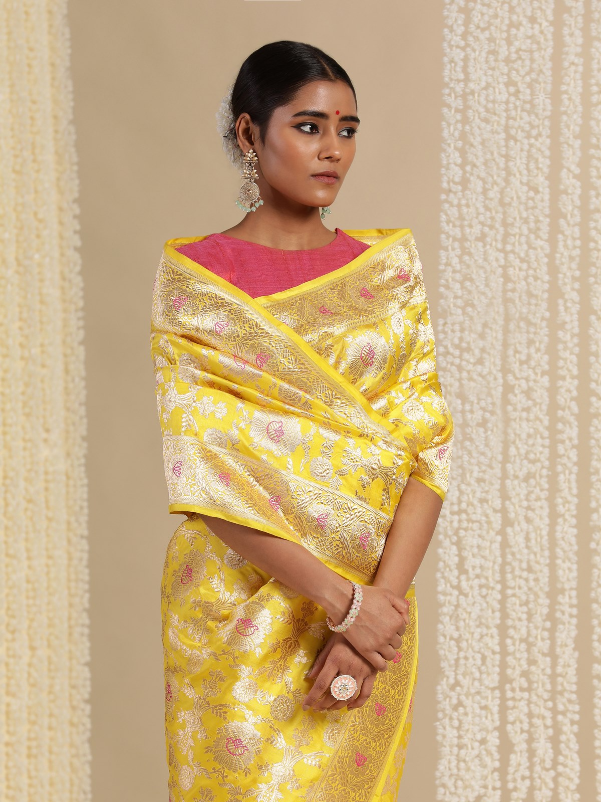 Detail close-up of intricate zari and silk weave on yellow mulberry Katan silk Banarasi saree