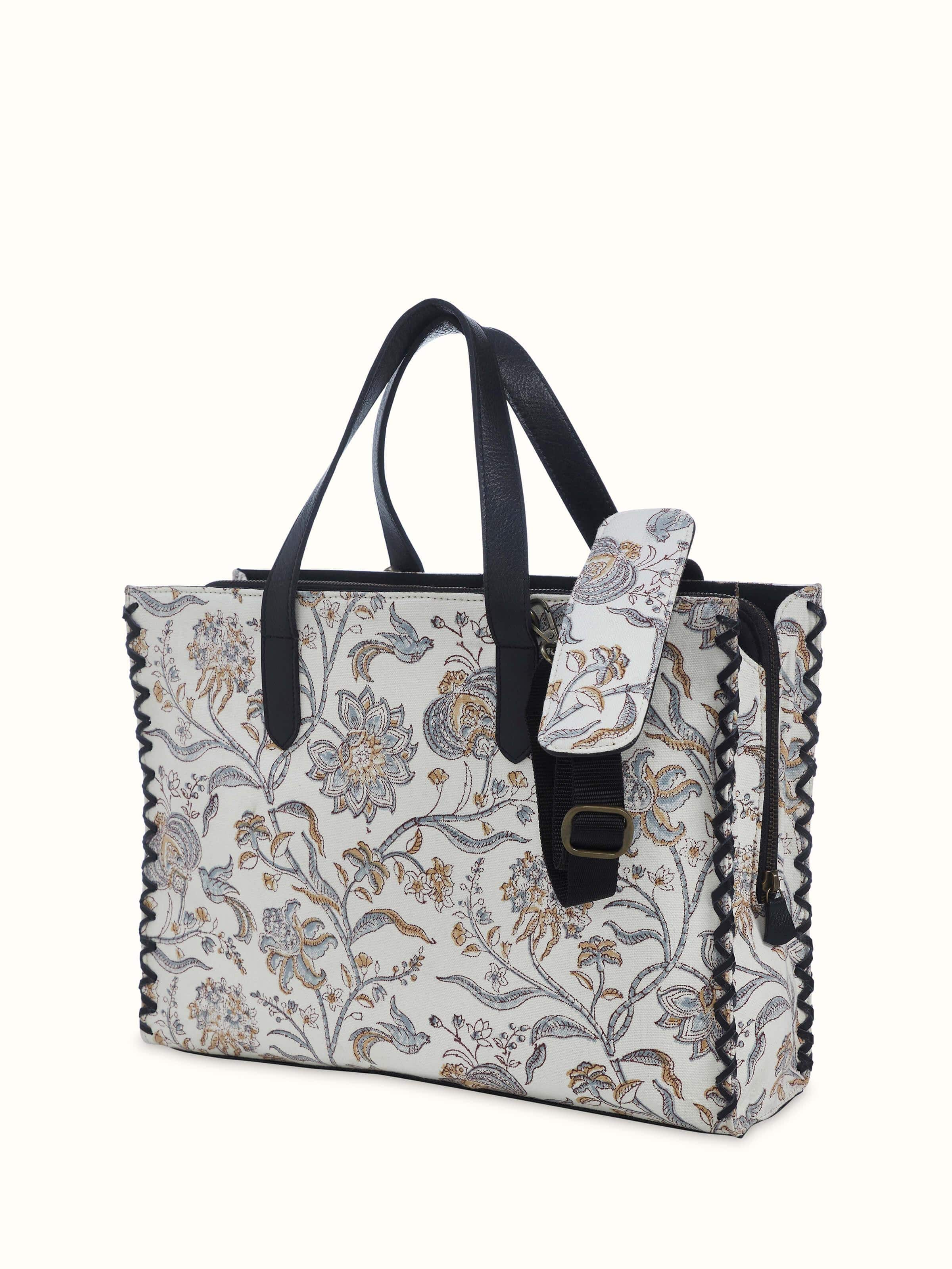 Black leather and textile hand block printed tote bag detail view showing block print texture and leather finish