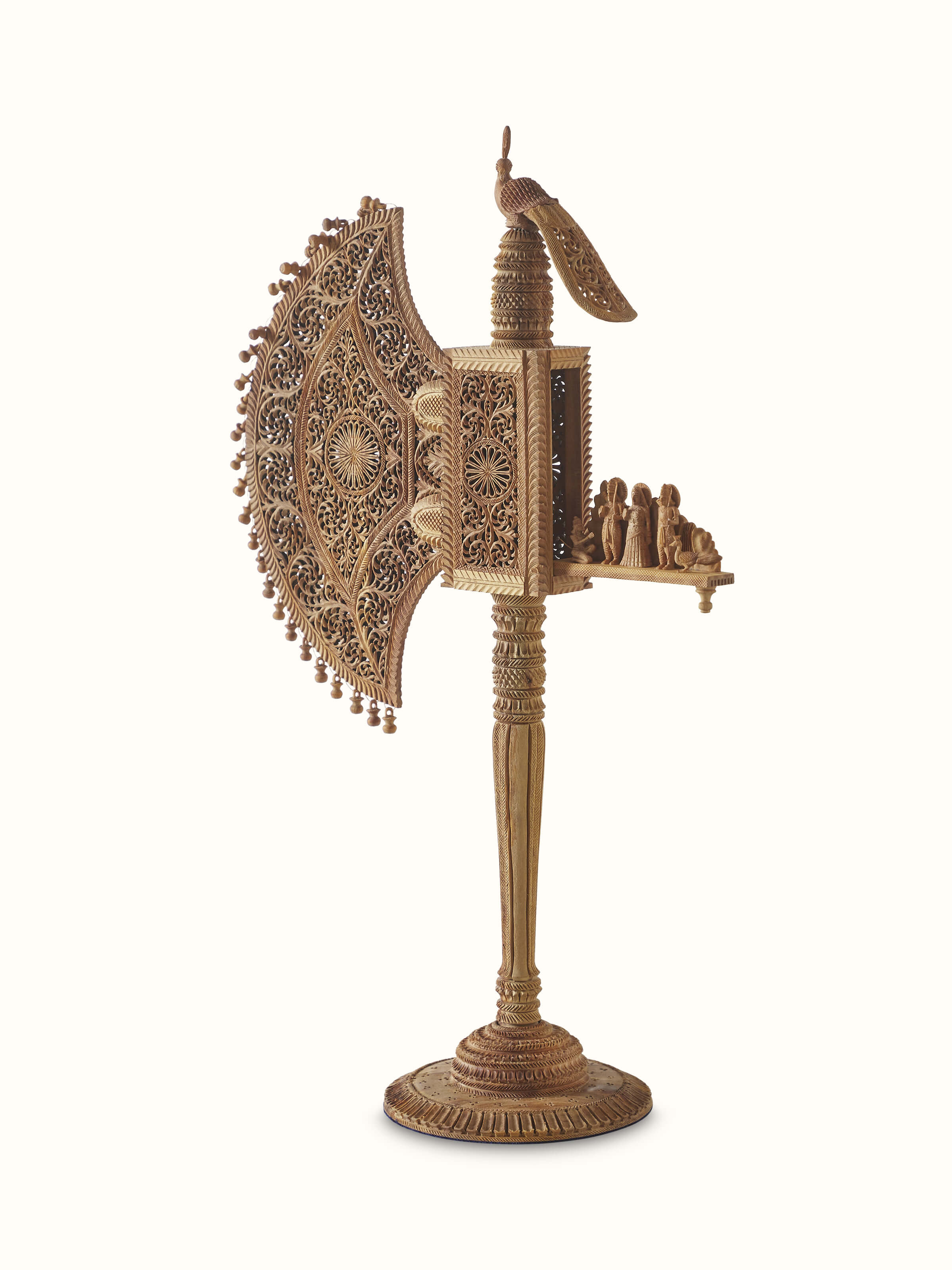 Close-up of Bilara carved sandalwood jaali fan sculpture focusing on the intricate jaali design