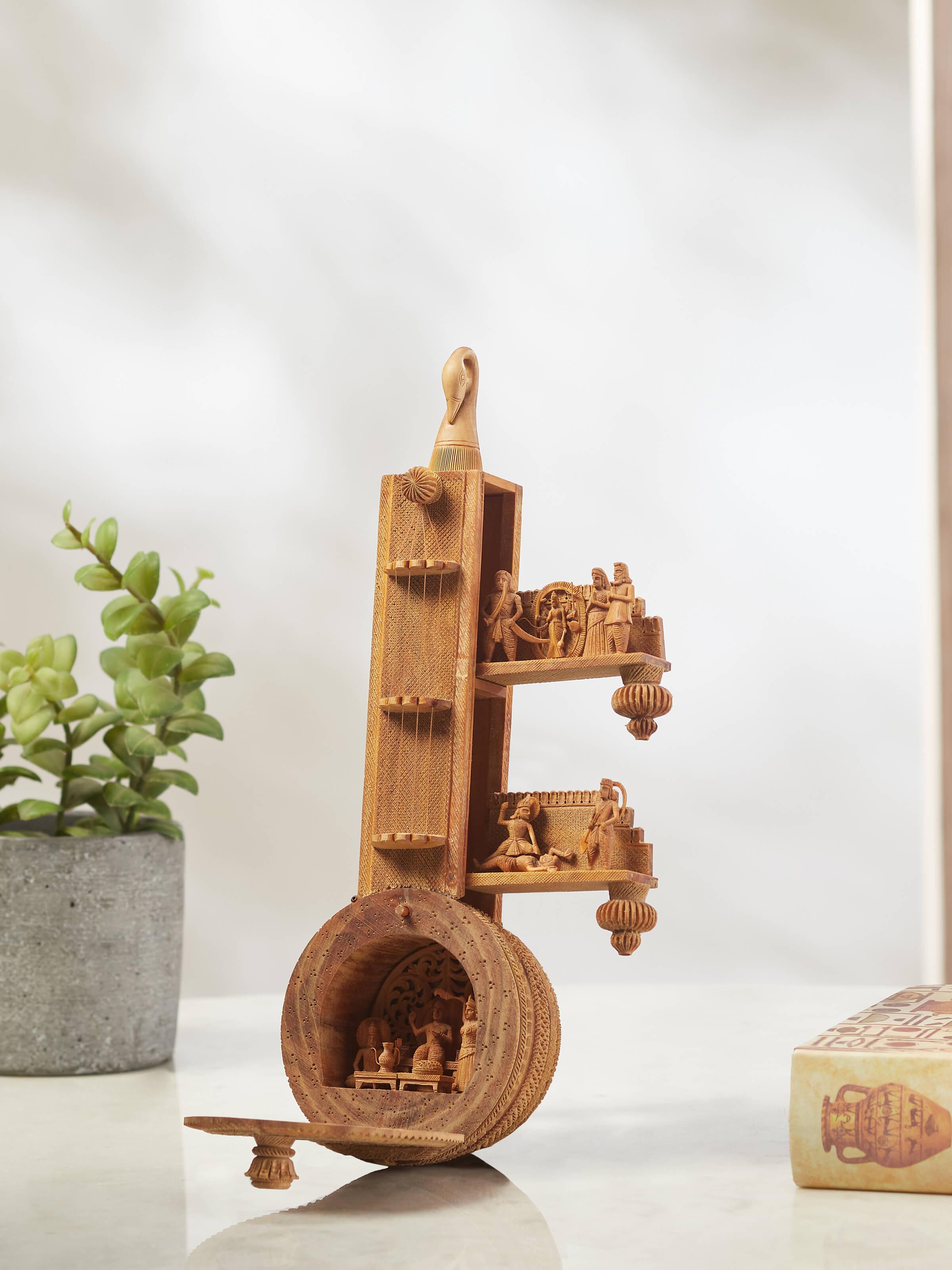 Close-up of carved sandalwood devotion veena sculpture, emphasizing the intricate designs and sculptural elements.