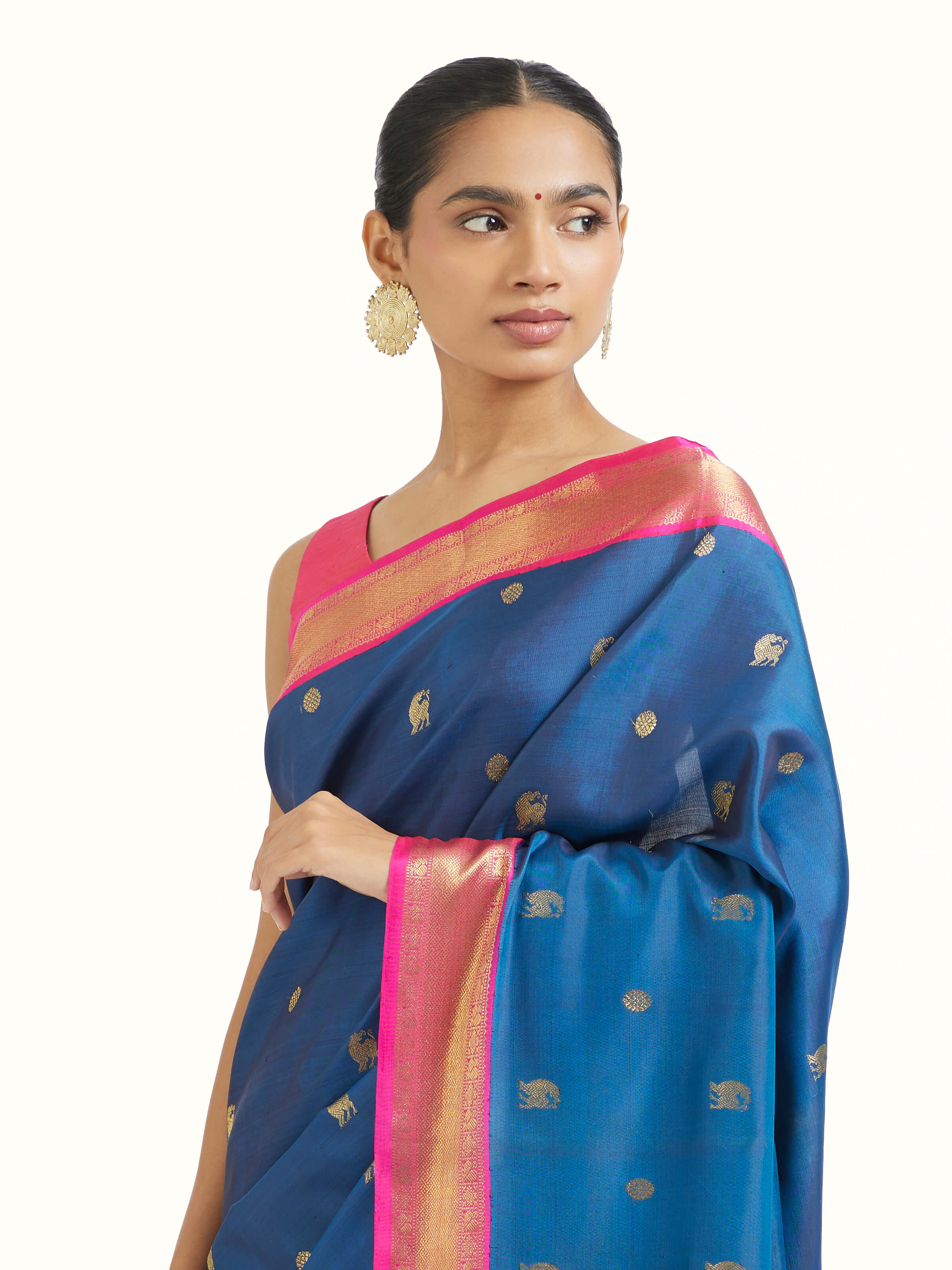 Angled view of dark blue silk Kancheepuram saree highlighting traditional weave and sheen