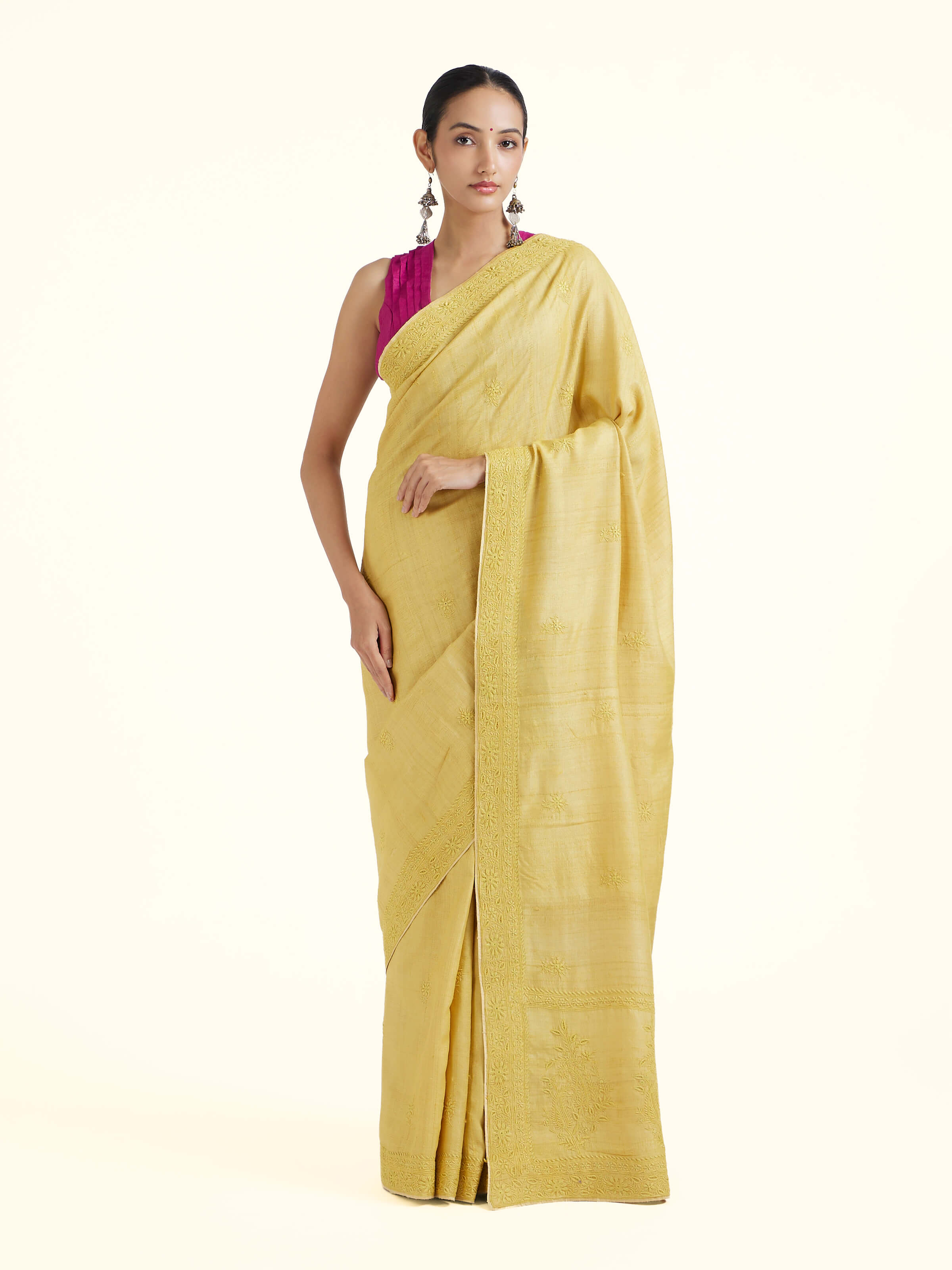 Front view of yellow silk Chikankari saree with delicate hand-embroidered motifs