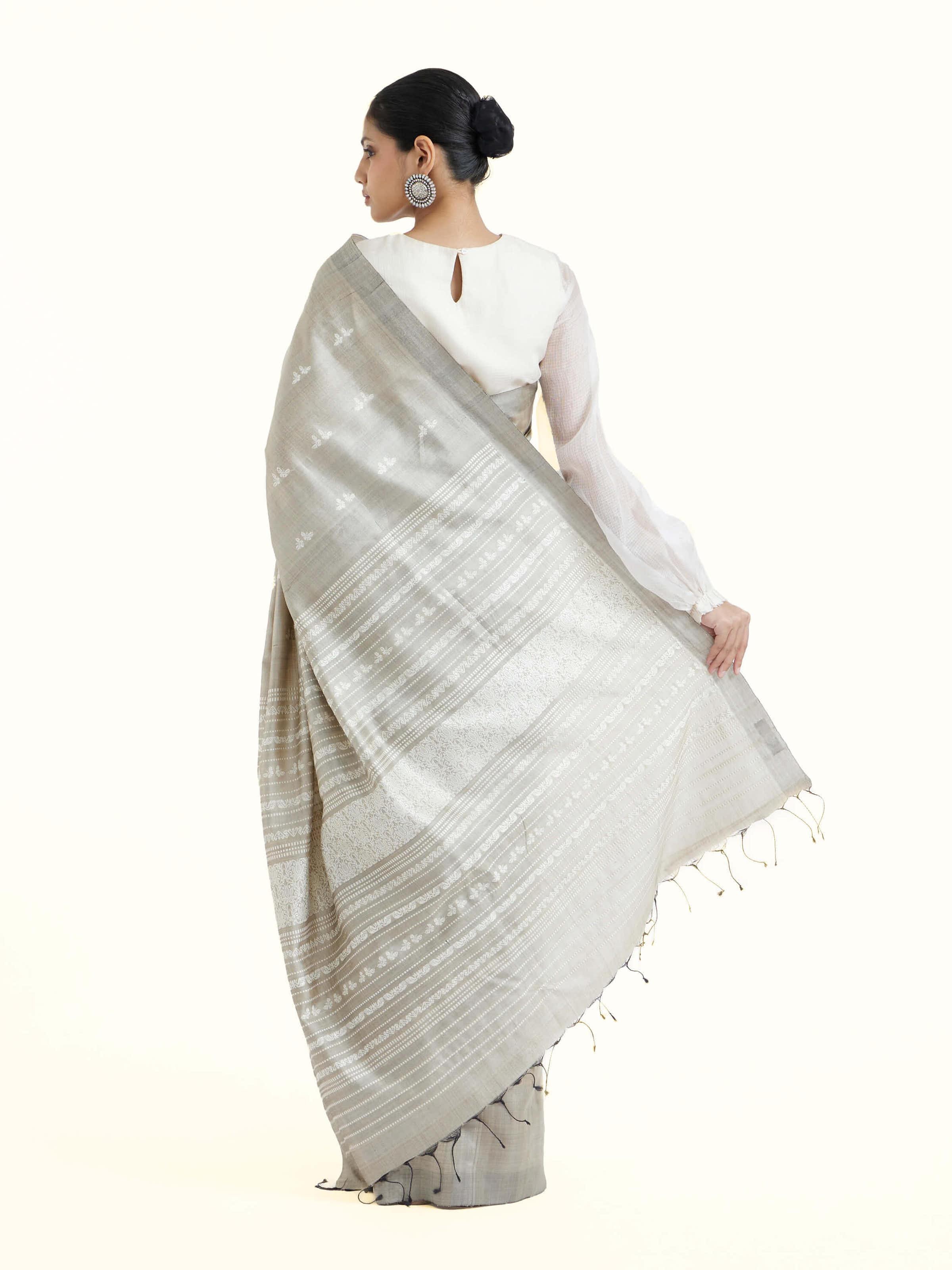 Back view of grey tussar silk Odisha ikat saree displaying ornate pallu design
