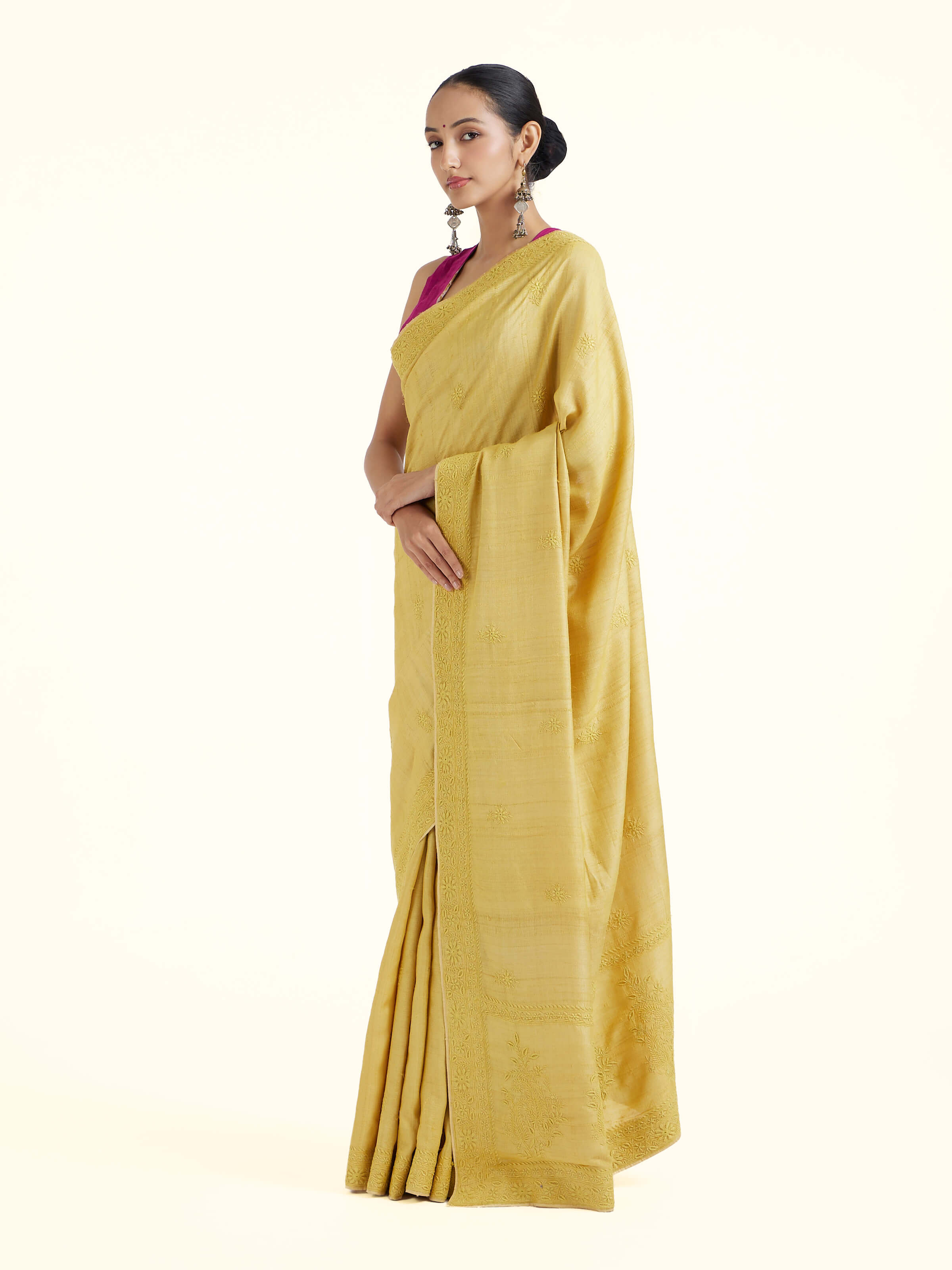 Side view of yellow silk Chikankari saree showcasing graceful drape