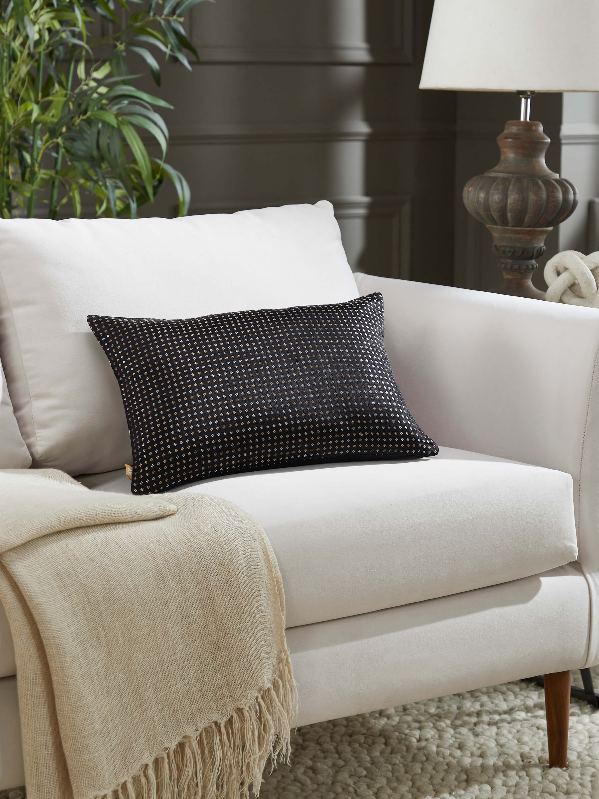 Lifestyle image of Awadh Lumbar Silk Cushion Cover on a sofa, offering regal decor vibes.