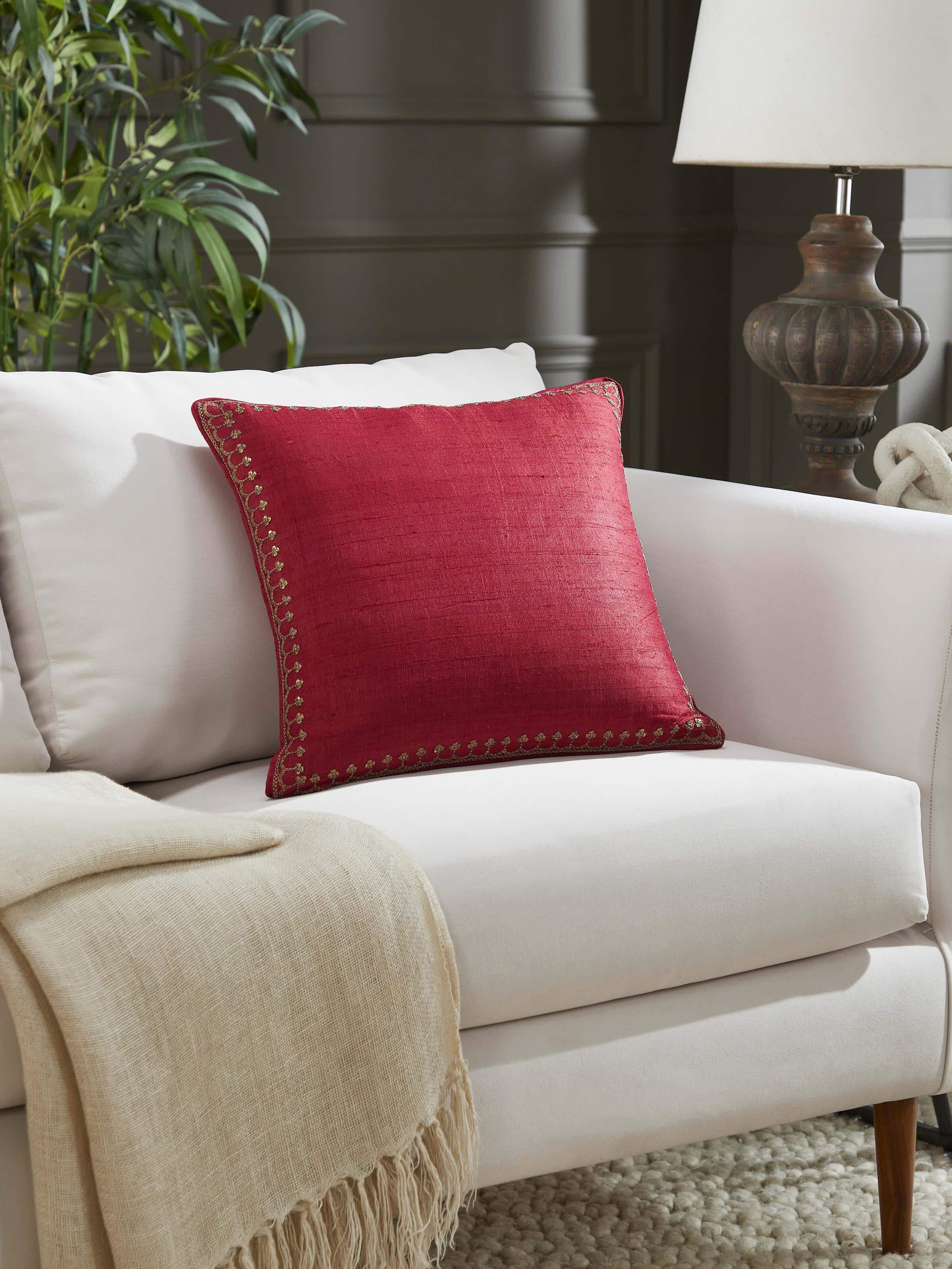 Lifestyle image of Alankar cushion on a sofa, adding a regal touch to home decor