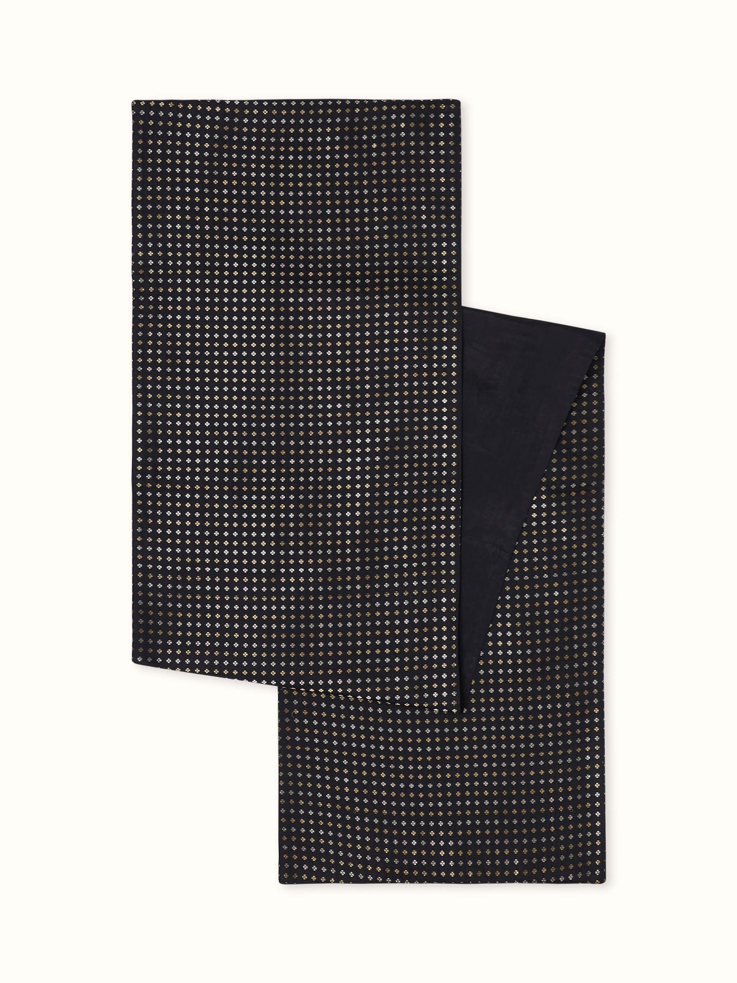 Angled view of black silk Banarasi brocade table runner with golden motifs and handloom texture.