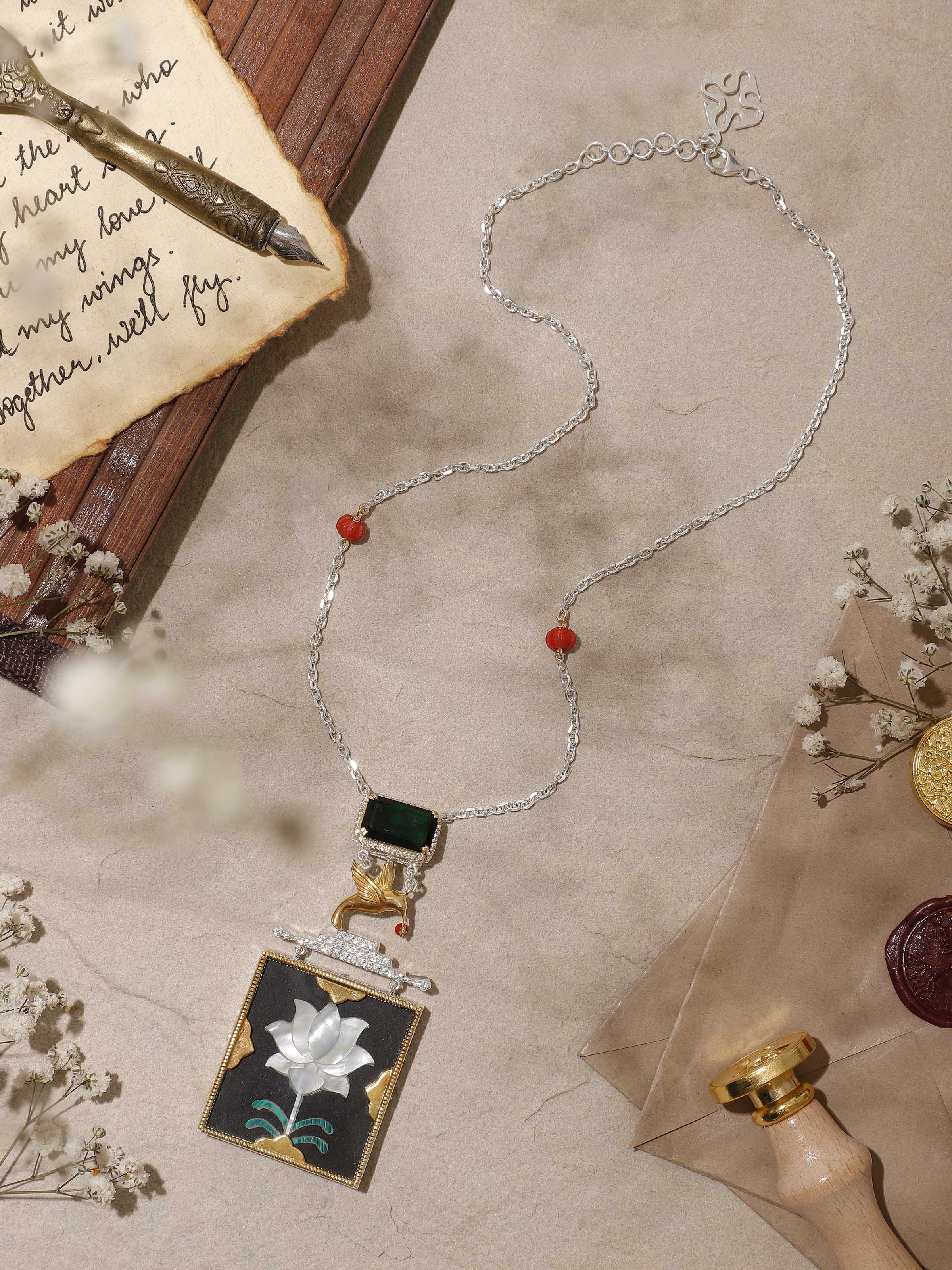 Side view highlighting the fine silver work and intricate design of the pendant