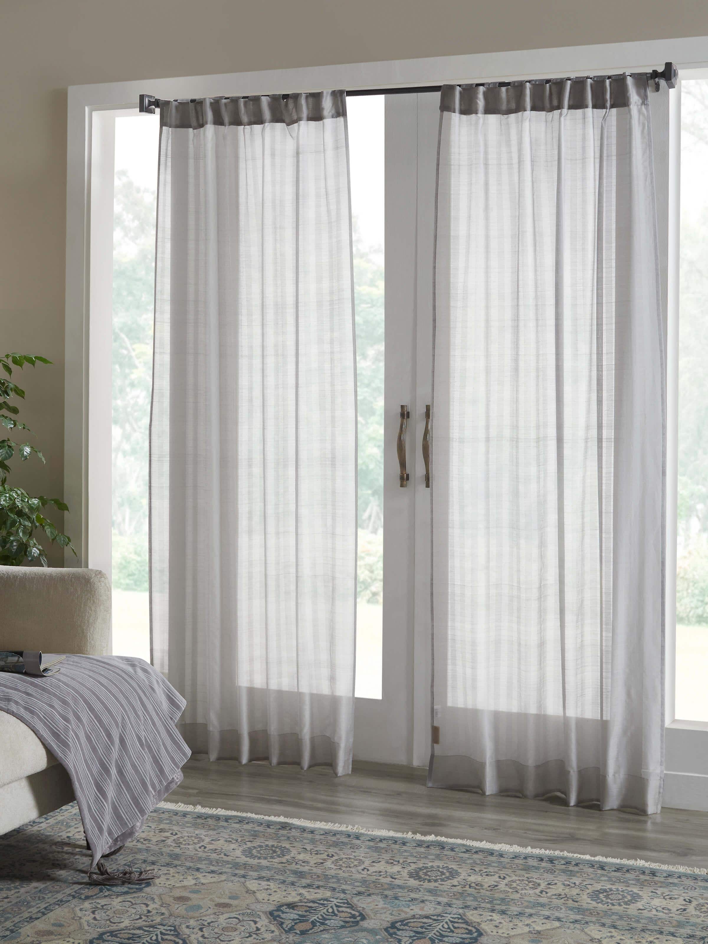 Lifestyle image of grey Maheshwari curtain bringing airy elegance to a modern window setting