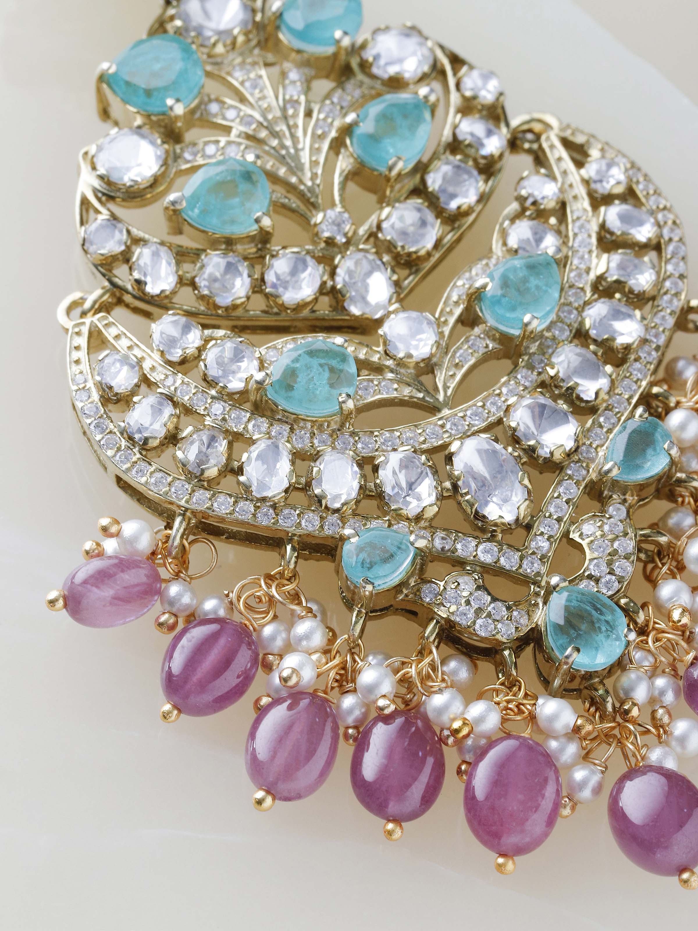 Close-up of handcrafted silver smithing detail on chandelier earrings