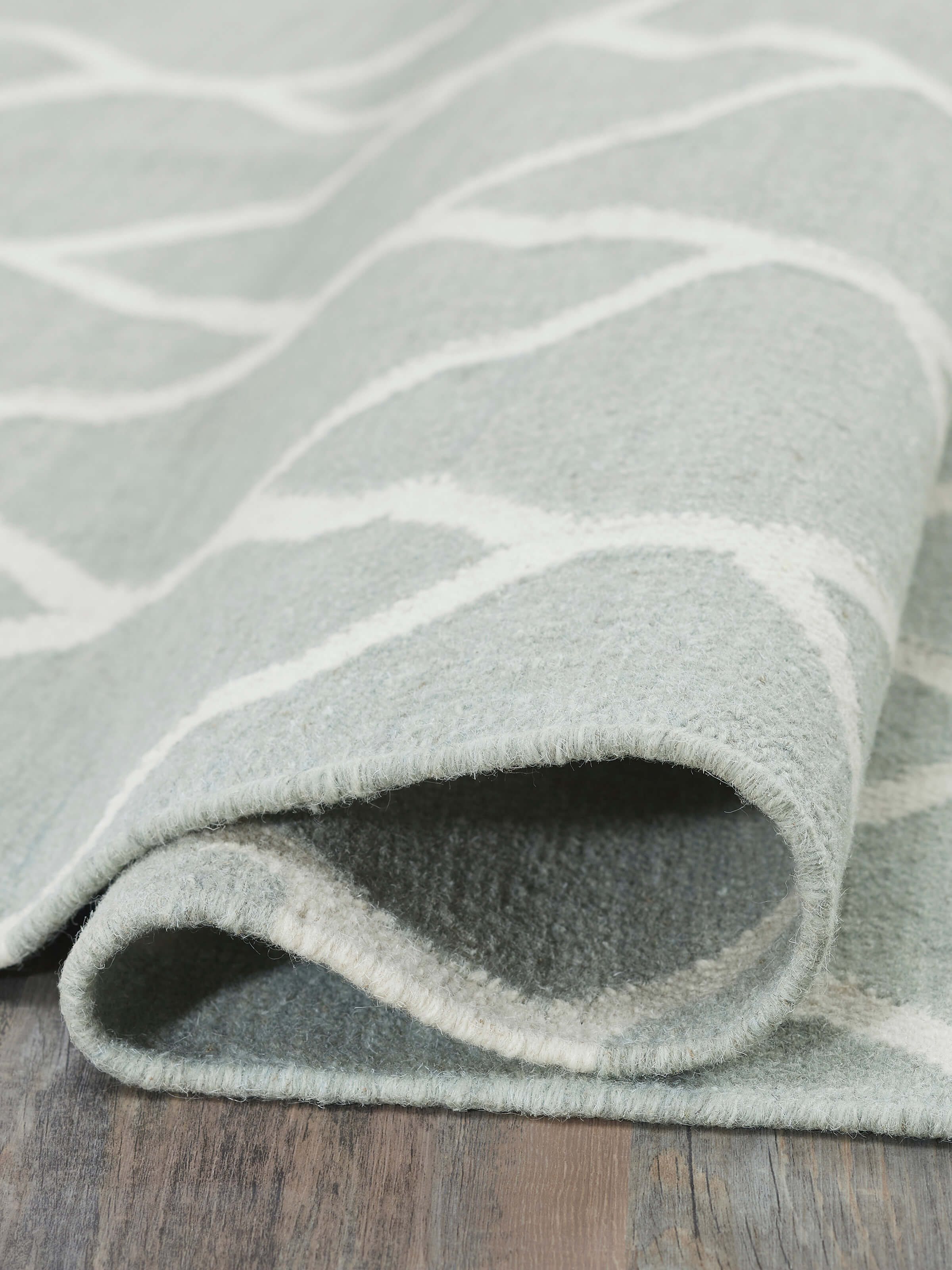 Side view emphasizing the dhurrie’s thickness and high-quality wool material