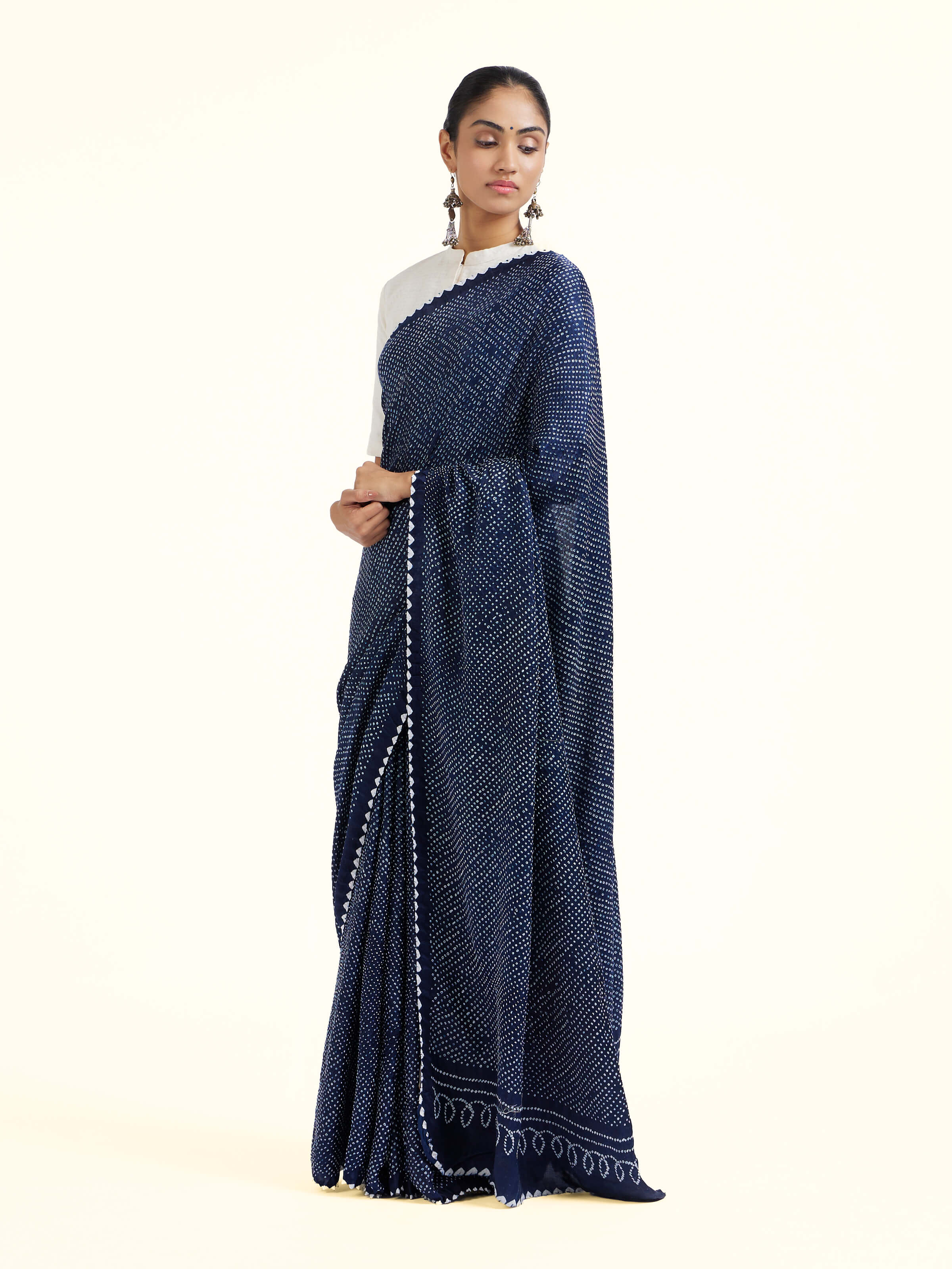 Side view of black silk tie and dye bandhani saree showcasing fluid drape
