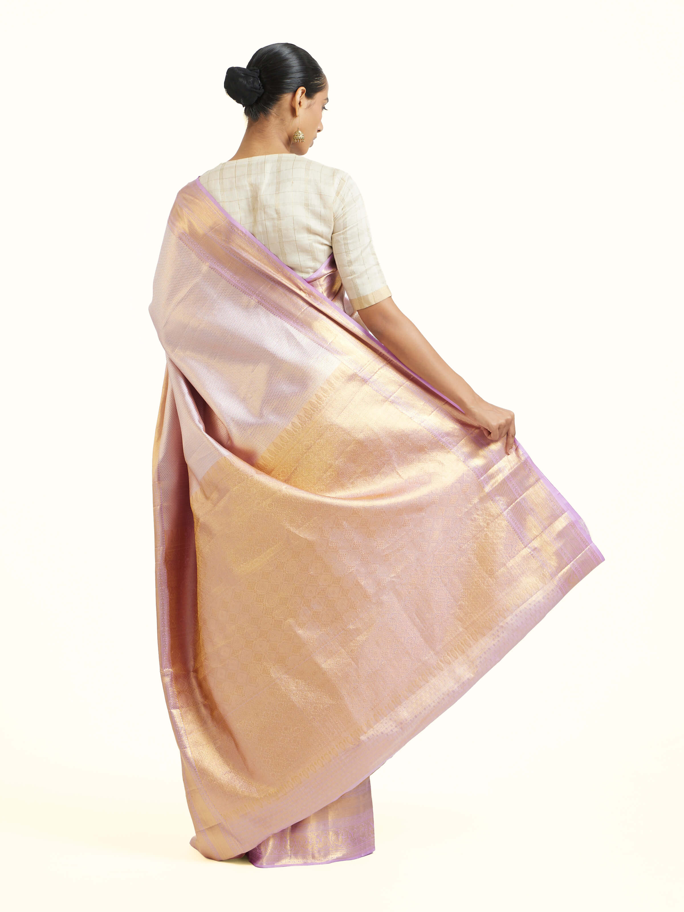 Back view of beige silk Kancheepuram saree displaying ornate pallu design