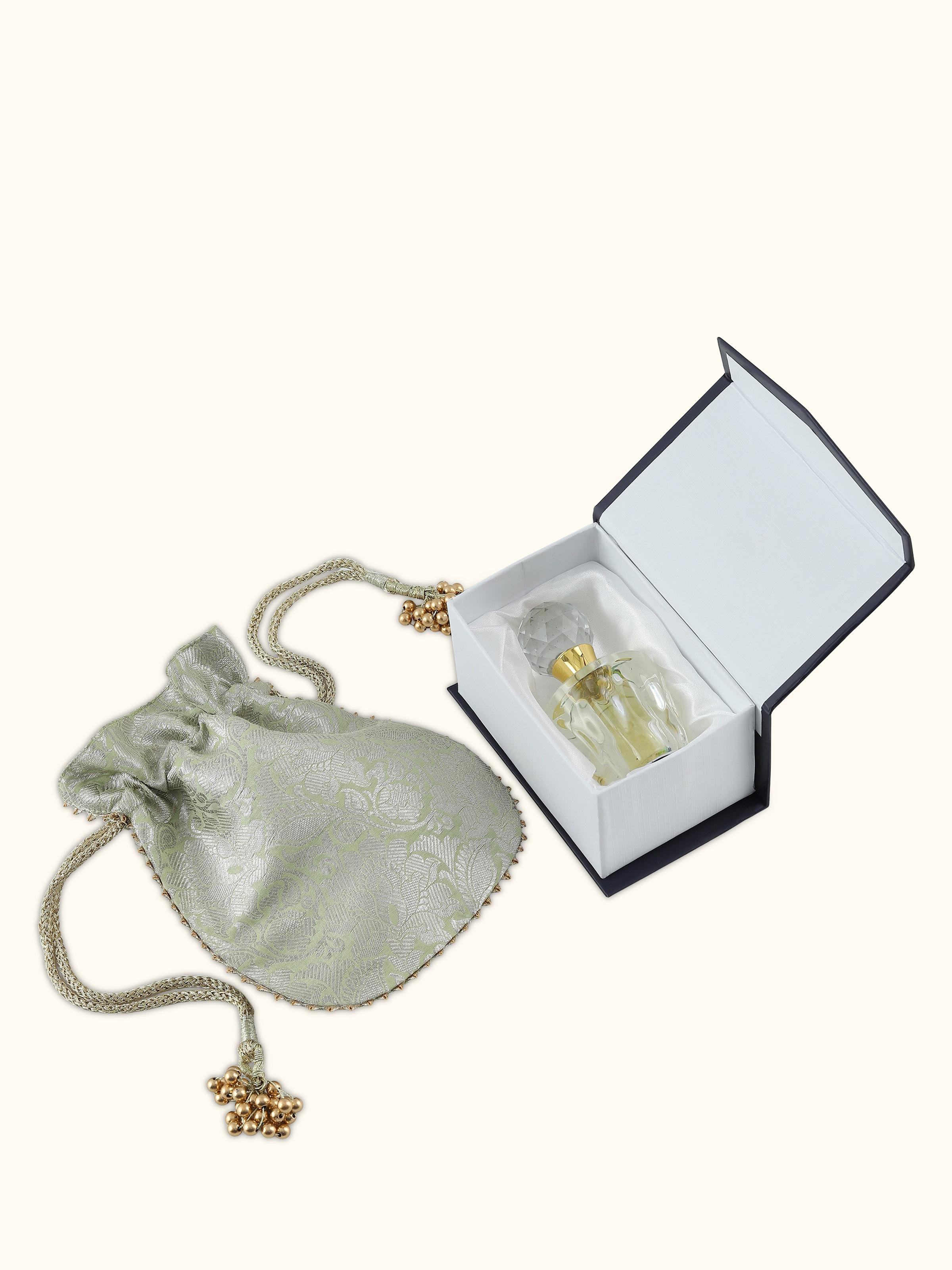 Overhead view of Attar Oudh Kashmiri perfume bottle with minimalistic golden cap and amber essence