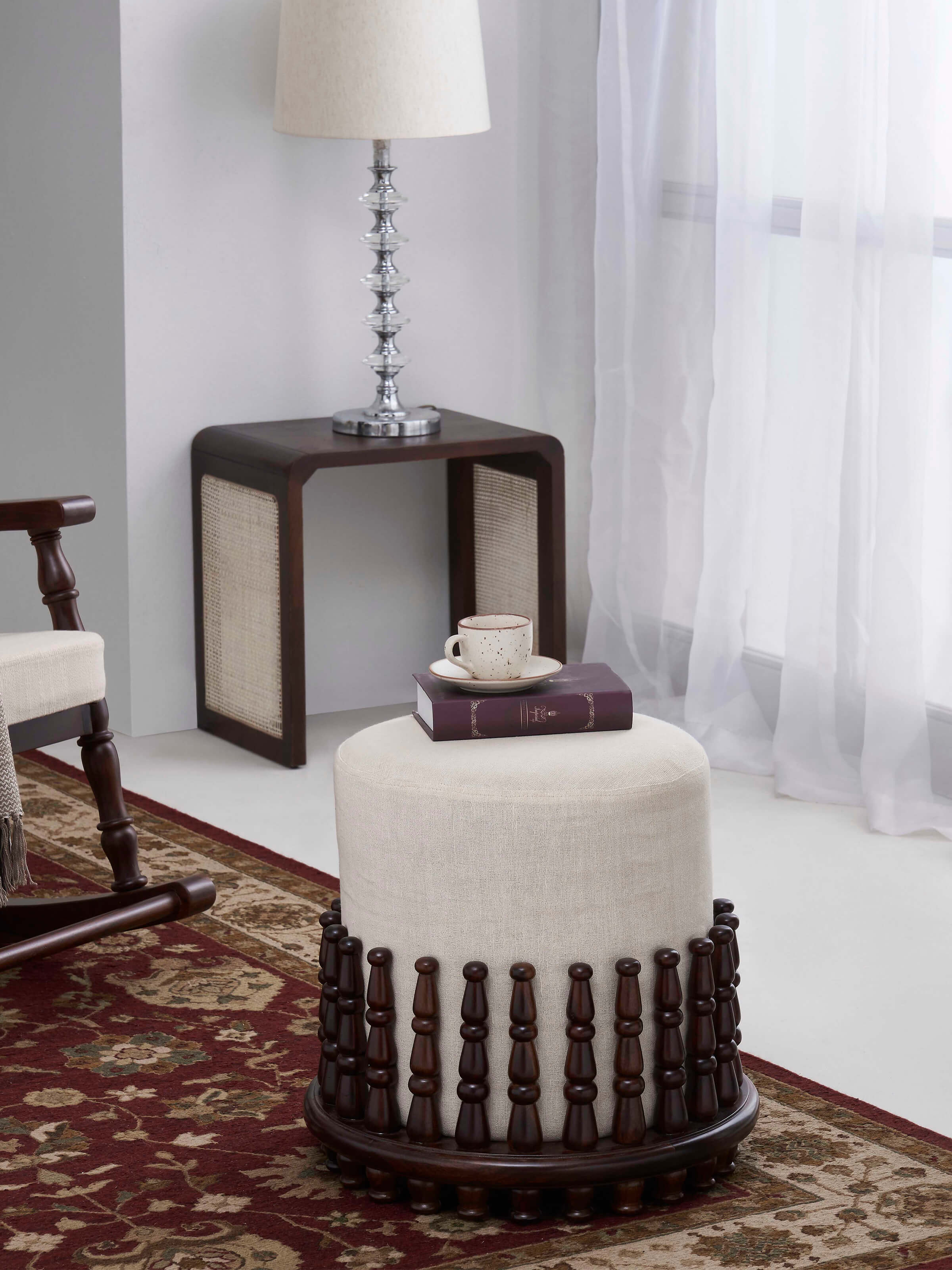 Side view of the square pouffe with Sheesham wood frame and upholstered top, showing the detailed stitching and craftsmanship