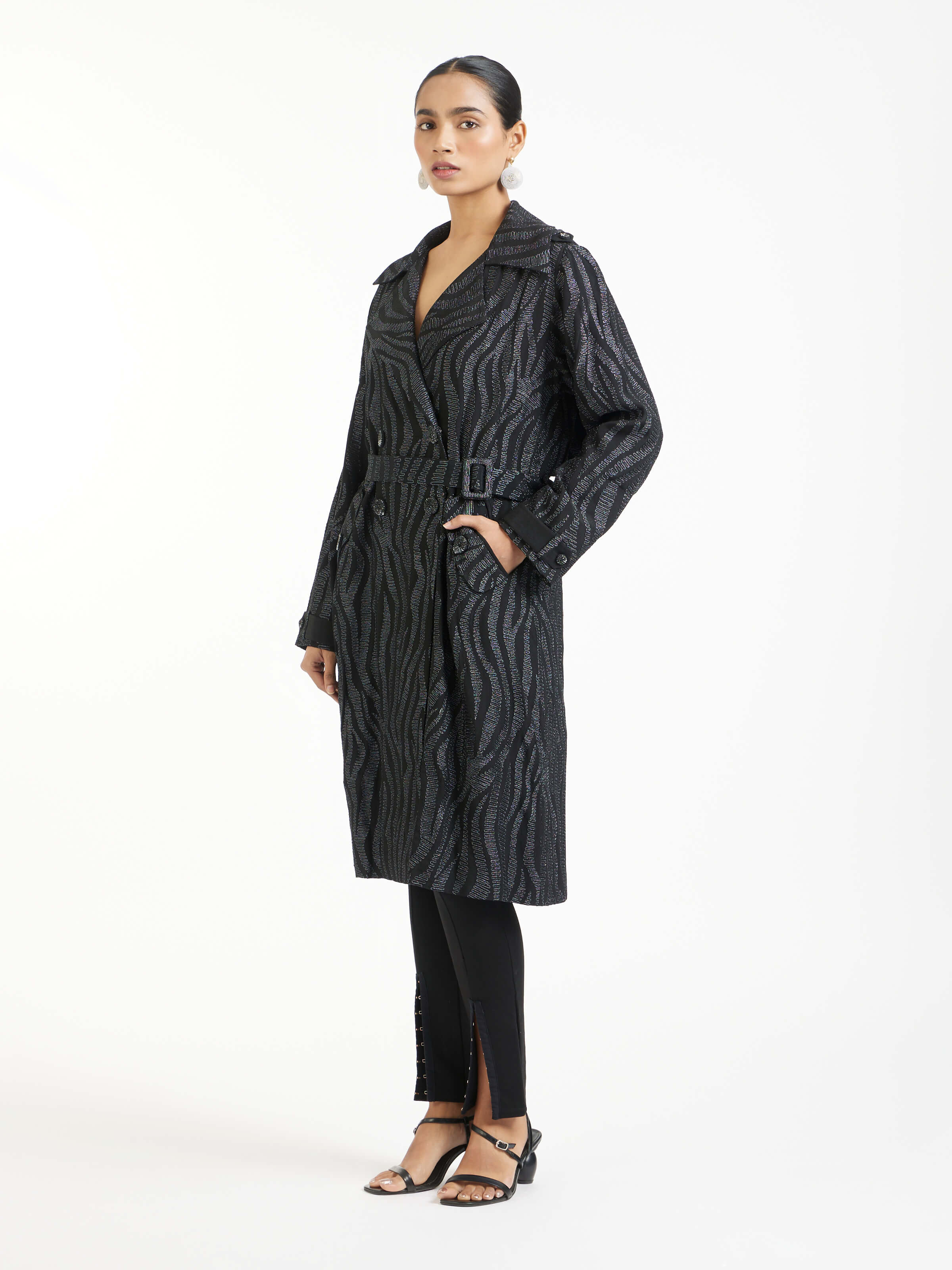 Side view of black aari hand embroidered trenchcoat highlighting tailored fit and detailing