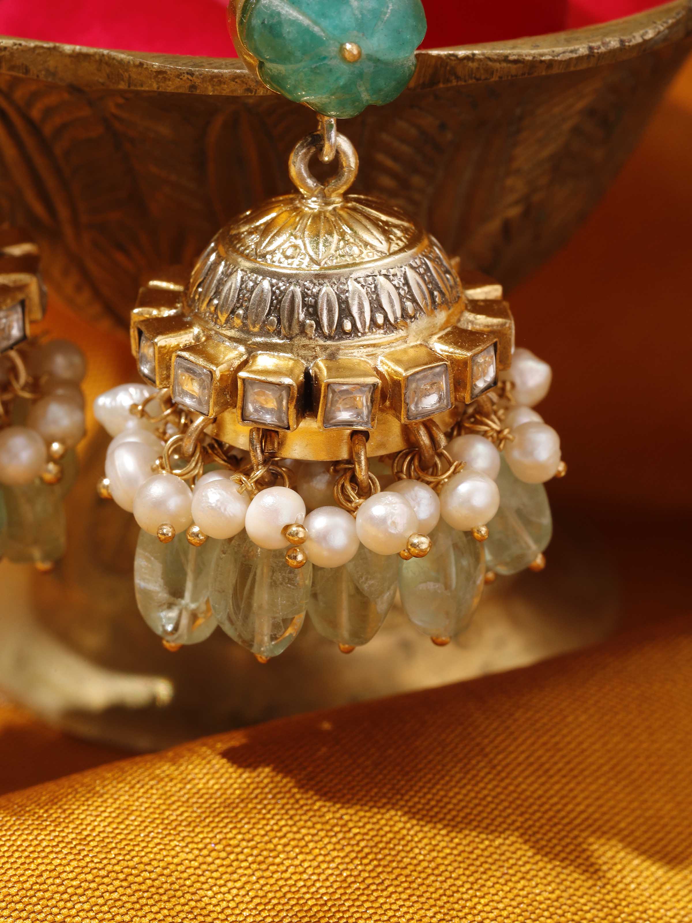 Detailed shot of Silver Smithing jhumkas showcasing the intricate dome and silver bead accents.