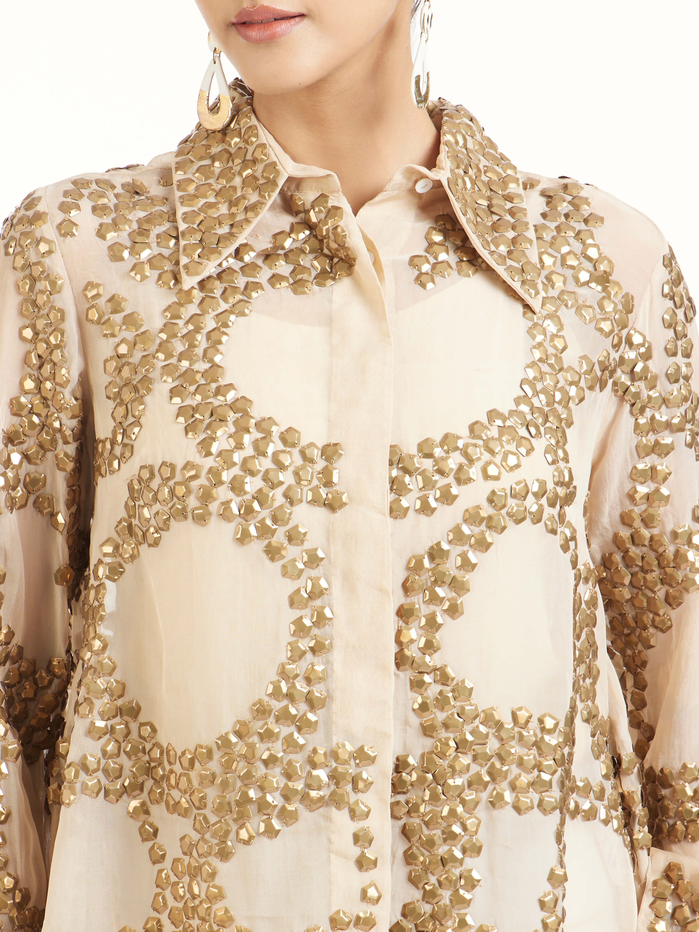 Detail view of beige hand embroidered organza gold shirt showing sheer texture