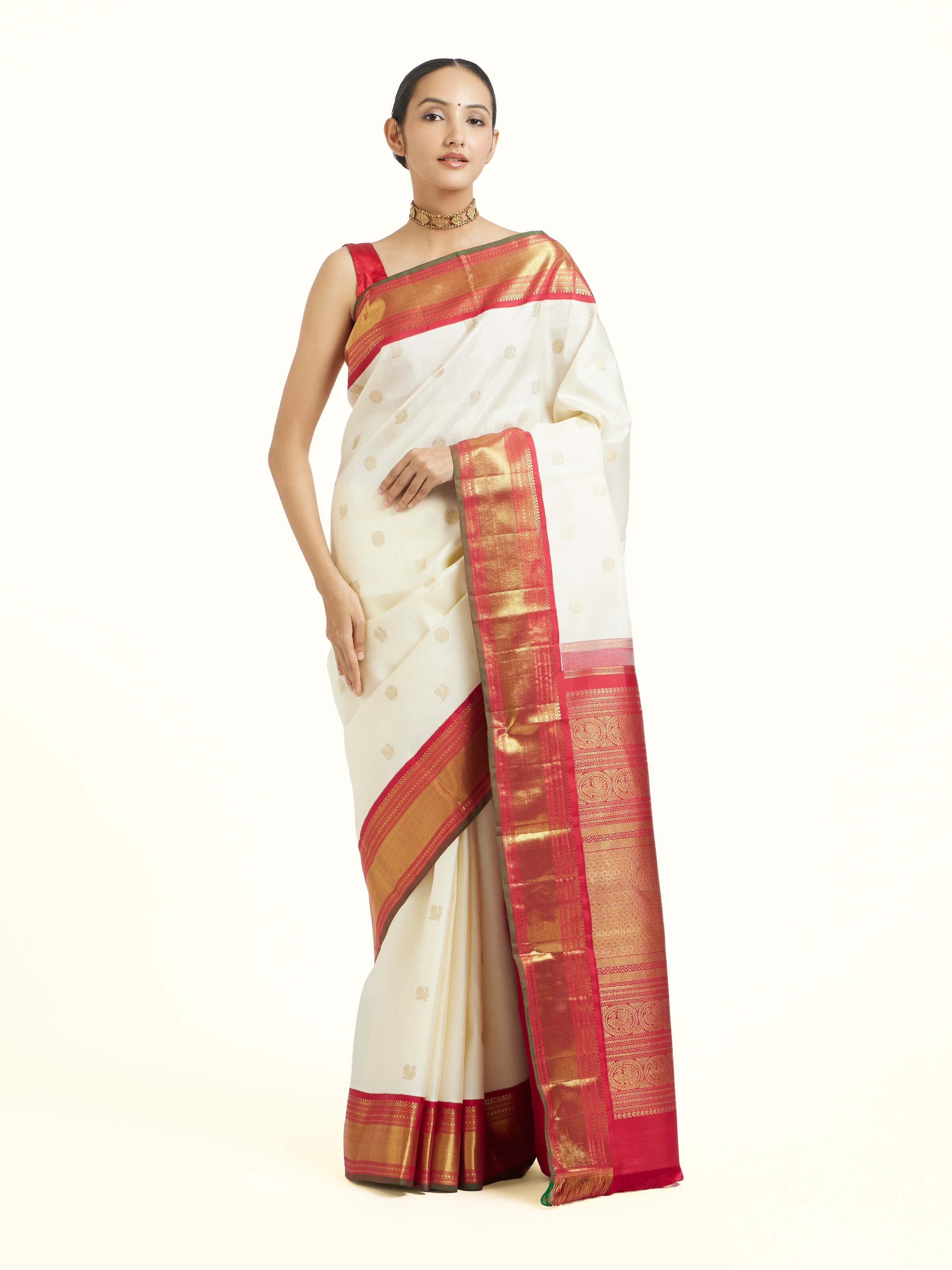 Front view of off-white silk Kancheepuram saree with rich zari woven motifs