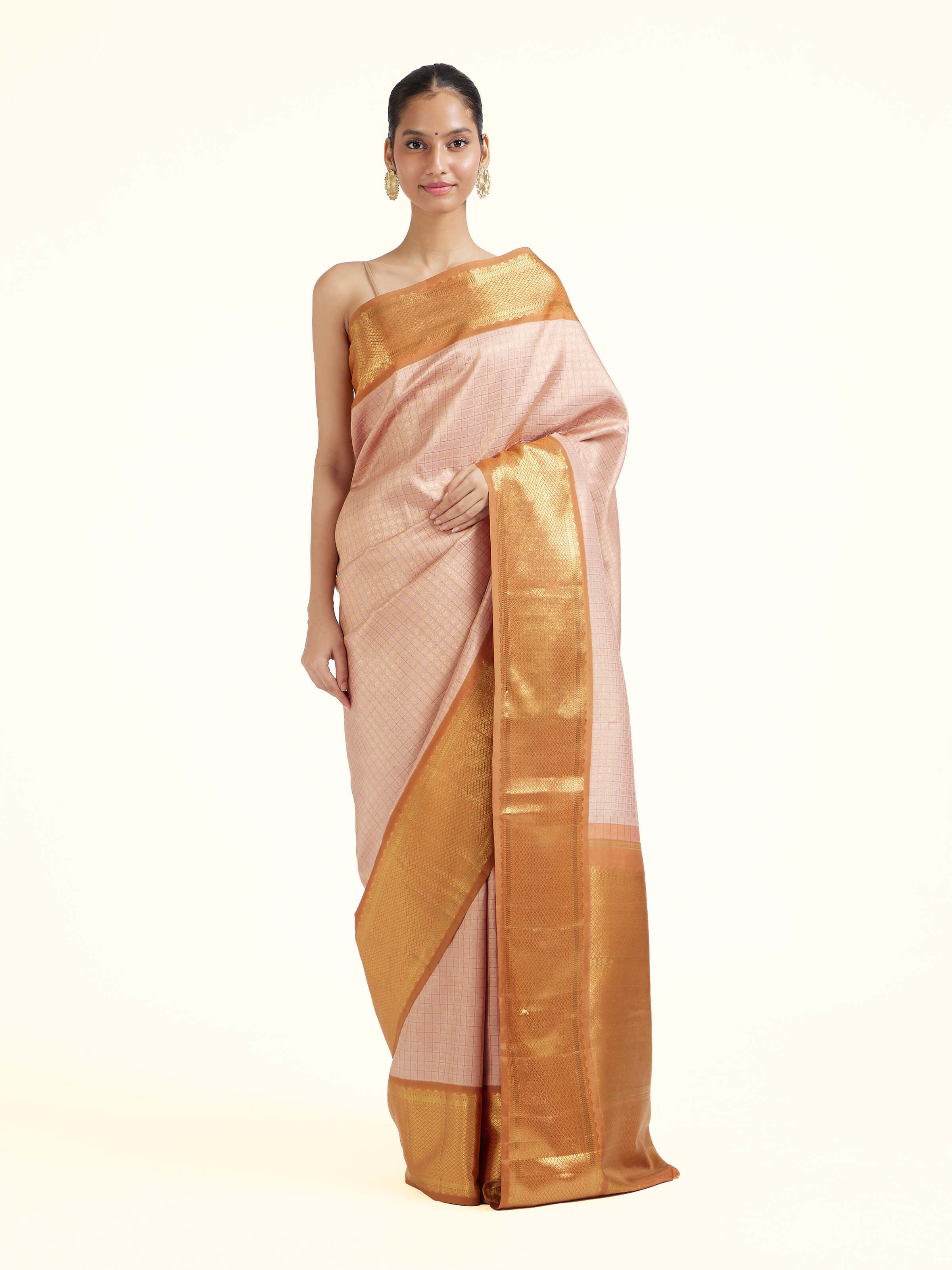 Front view of pink silk Kancheepuram saree with rich zari woven motifs
