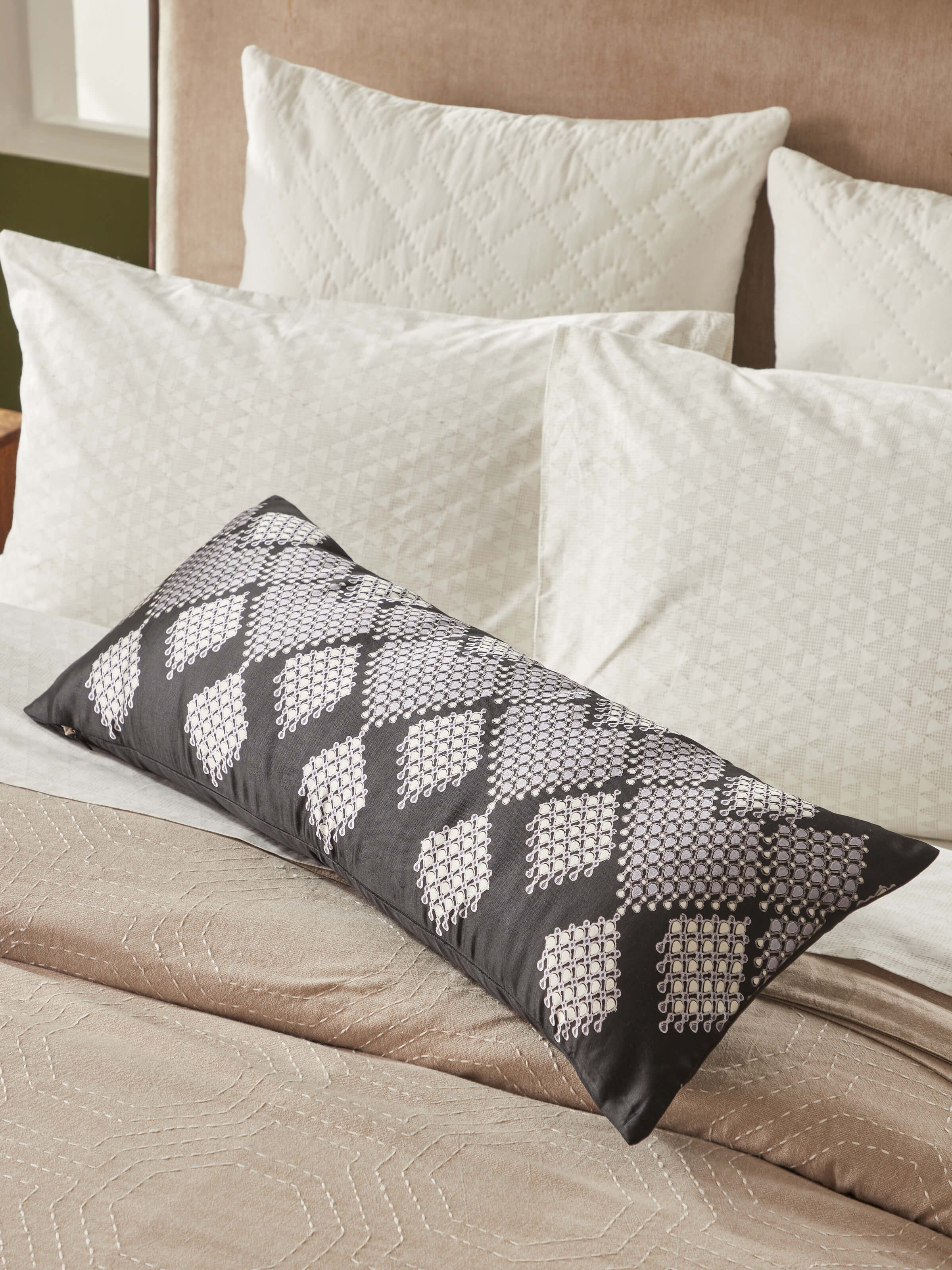 Lifestyle view: Rambagh black Sanganeri block printed cushion cover styled on sofa in modern home setting