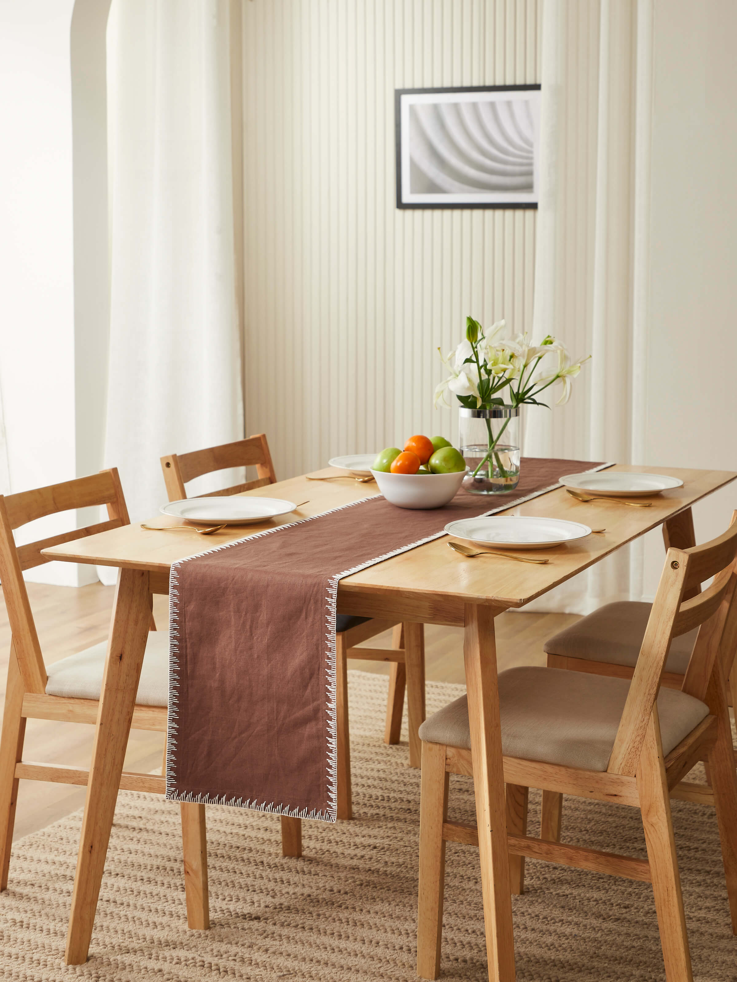 Brown edge stitch hand embroidered table mat placed on dining table