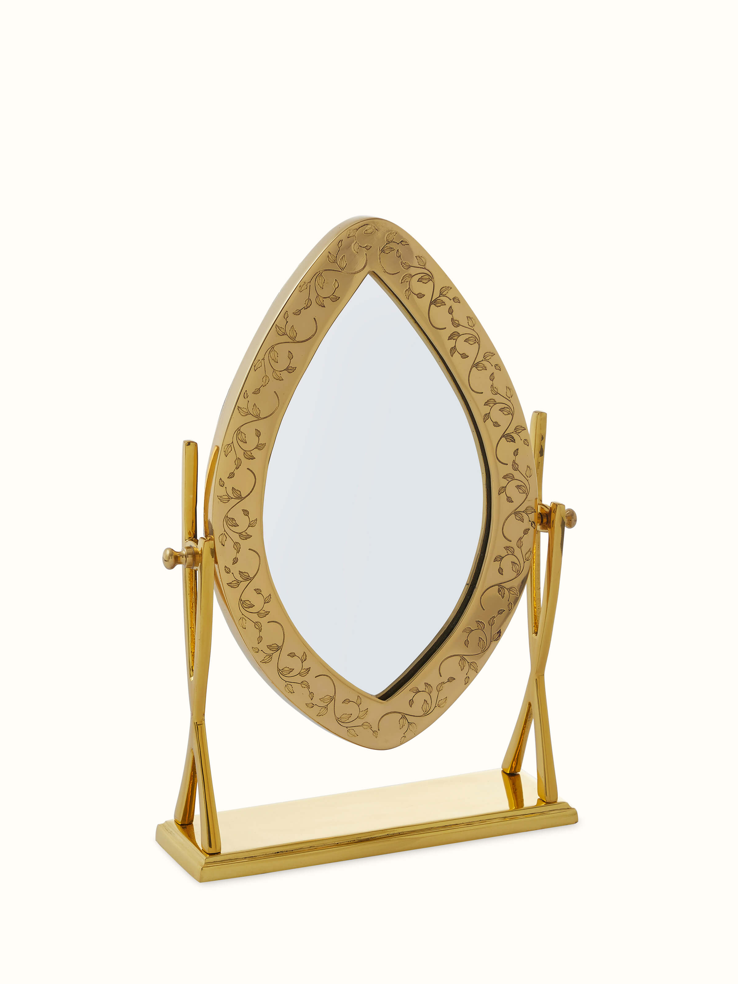 Angled view of Natural Brass Table Mirror from Swadesh, showcasing its elegant structure and reflective surface.