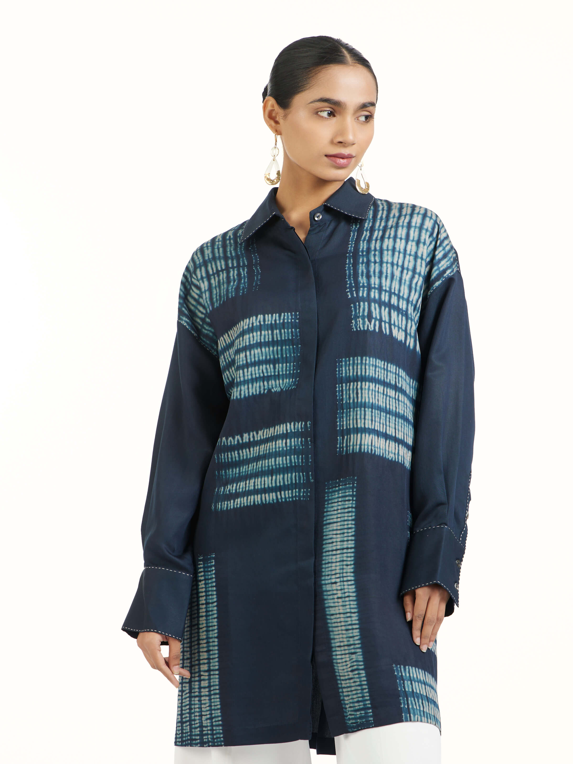 Angled view of blue shibori long shirt highlighting shibori dye work