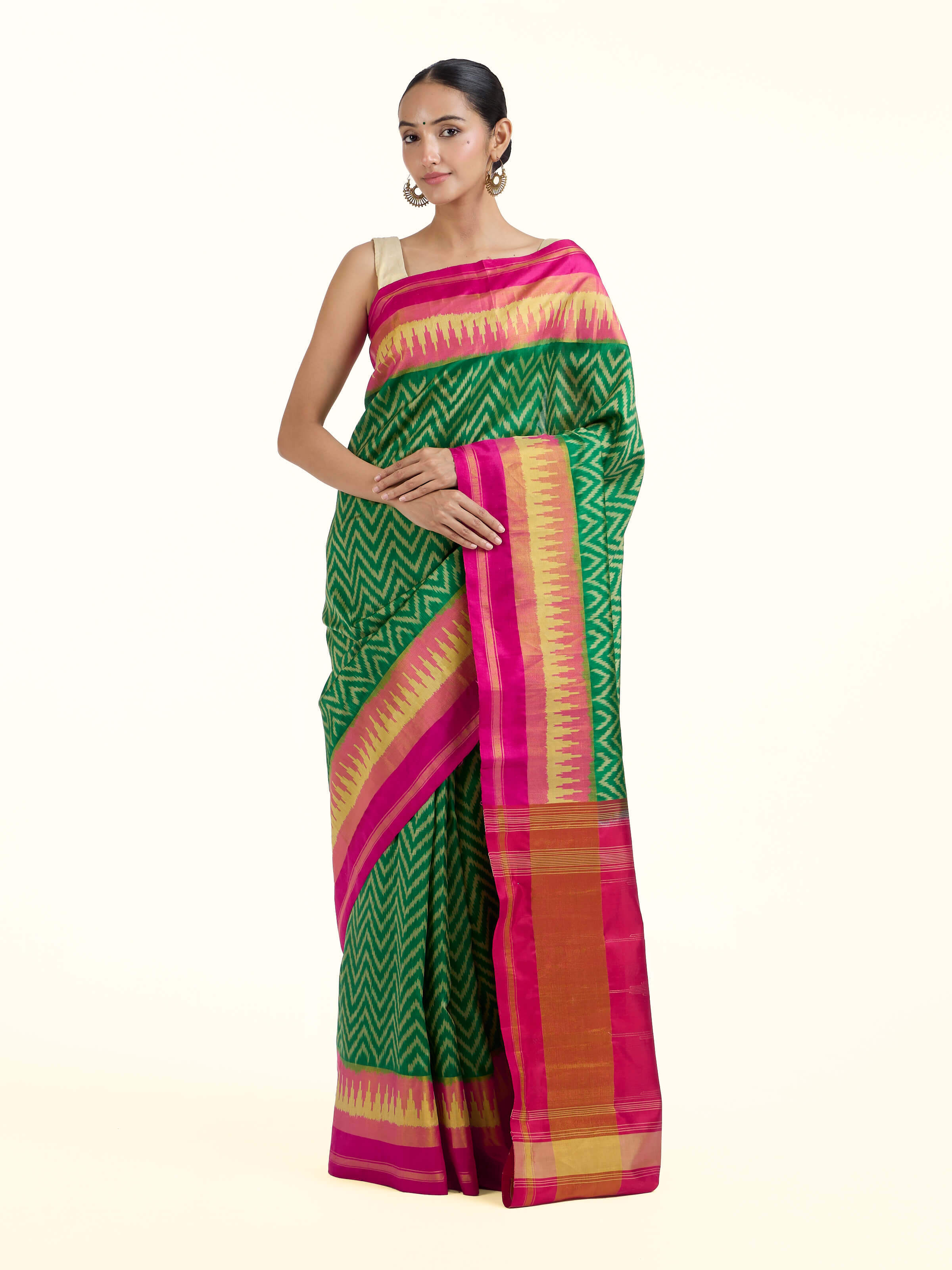 Front view of green mulberry silk patola saree with traditional double ikat woven motifs