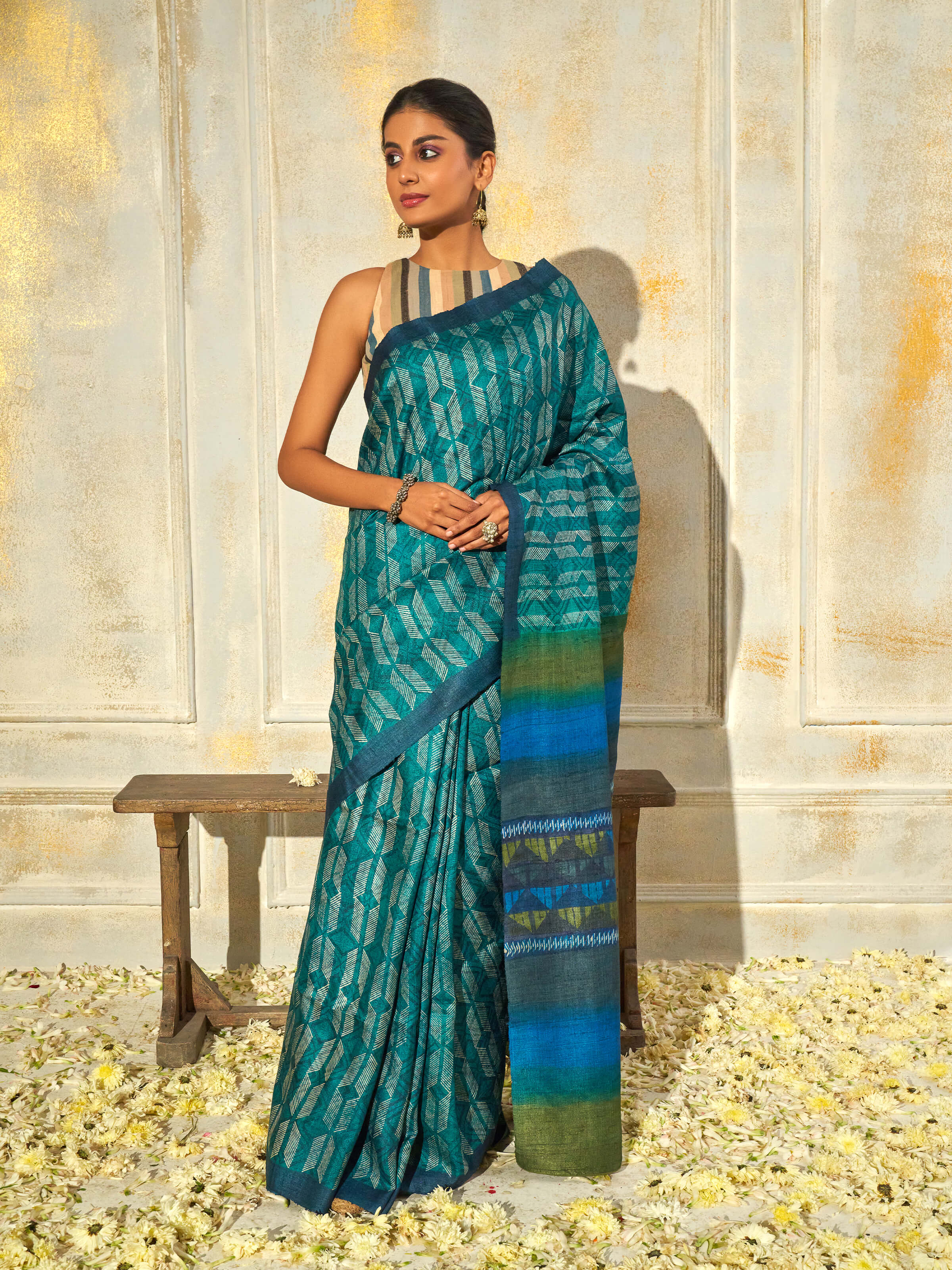 Side view of sea green tussar silk discharge block printed saree showcasing fluid drape