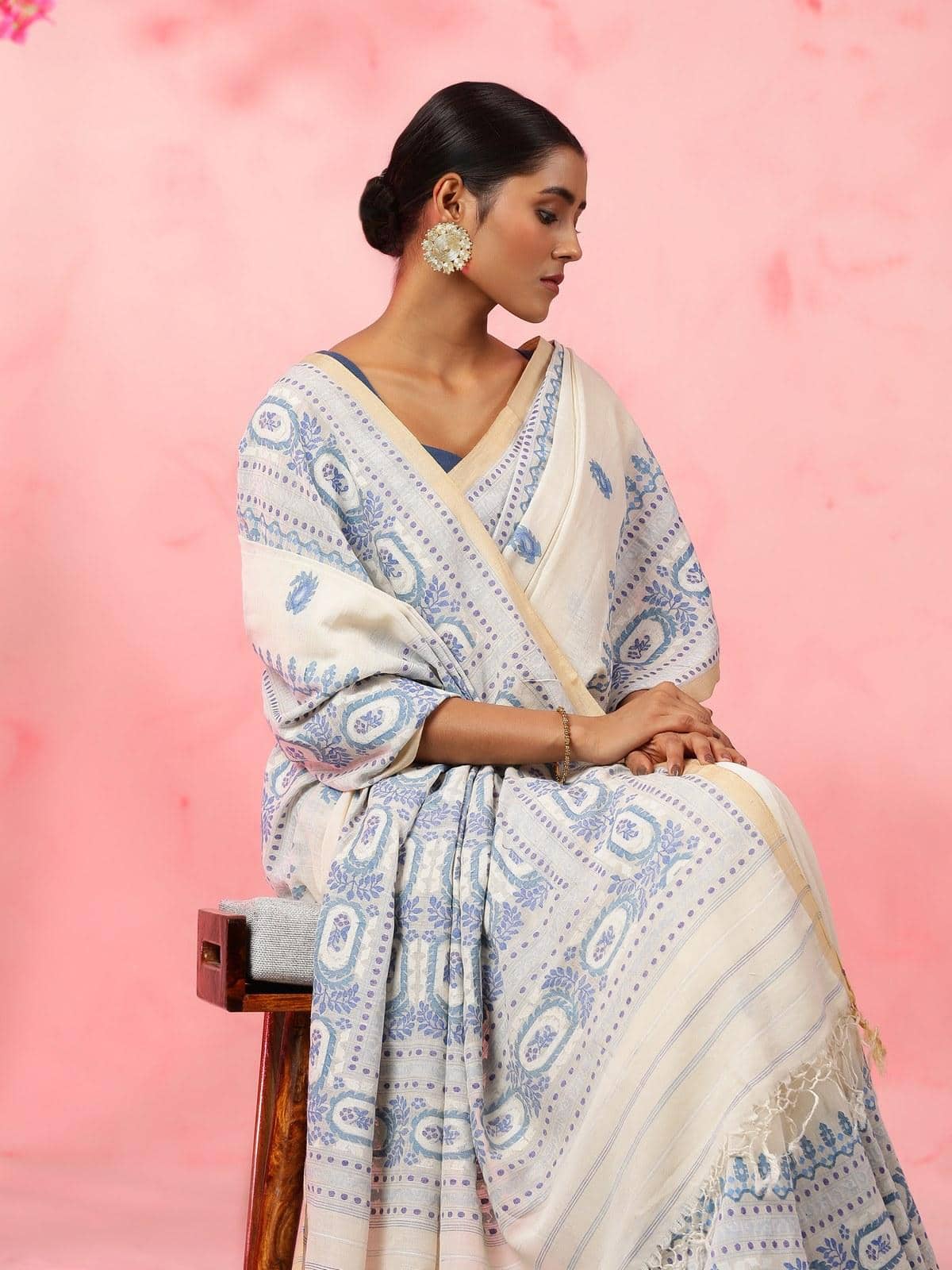 Angled view of off-white cotton Jamdani saree showing texture and fabric flow