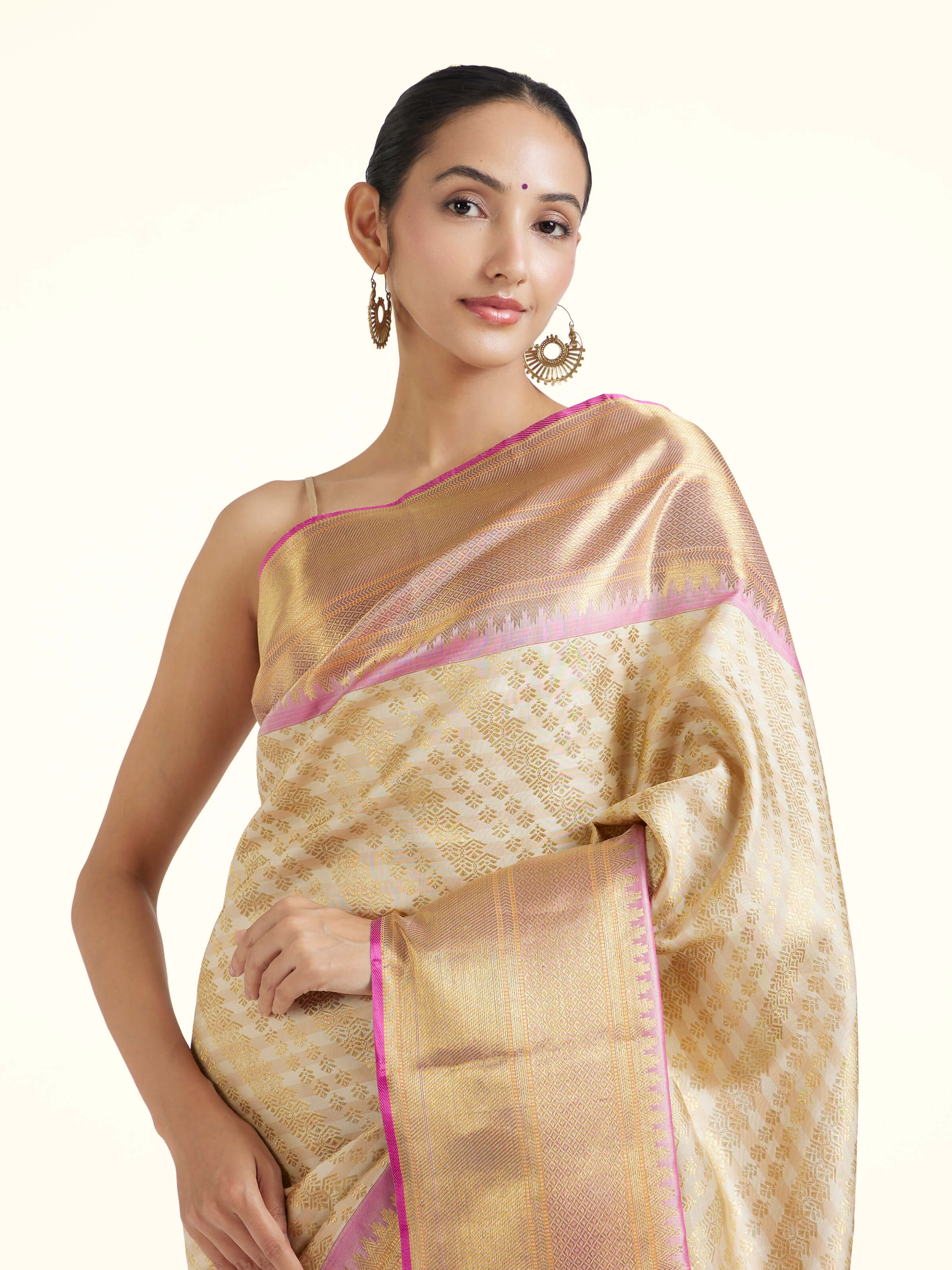 Angled view of off-white silk Kancheepuram saree highlighting intricate zari work