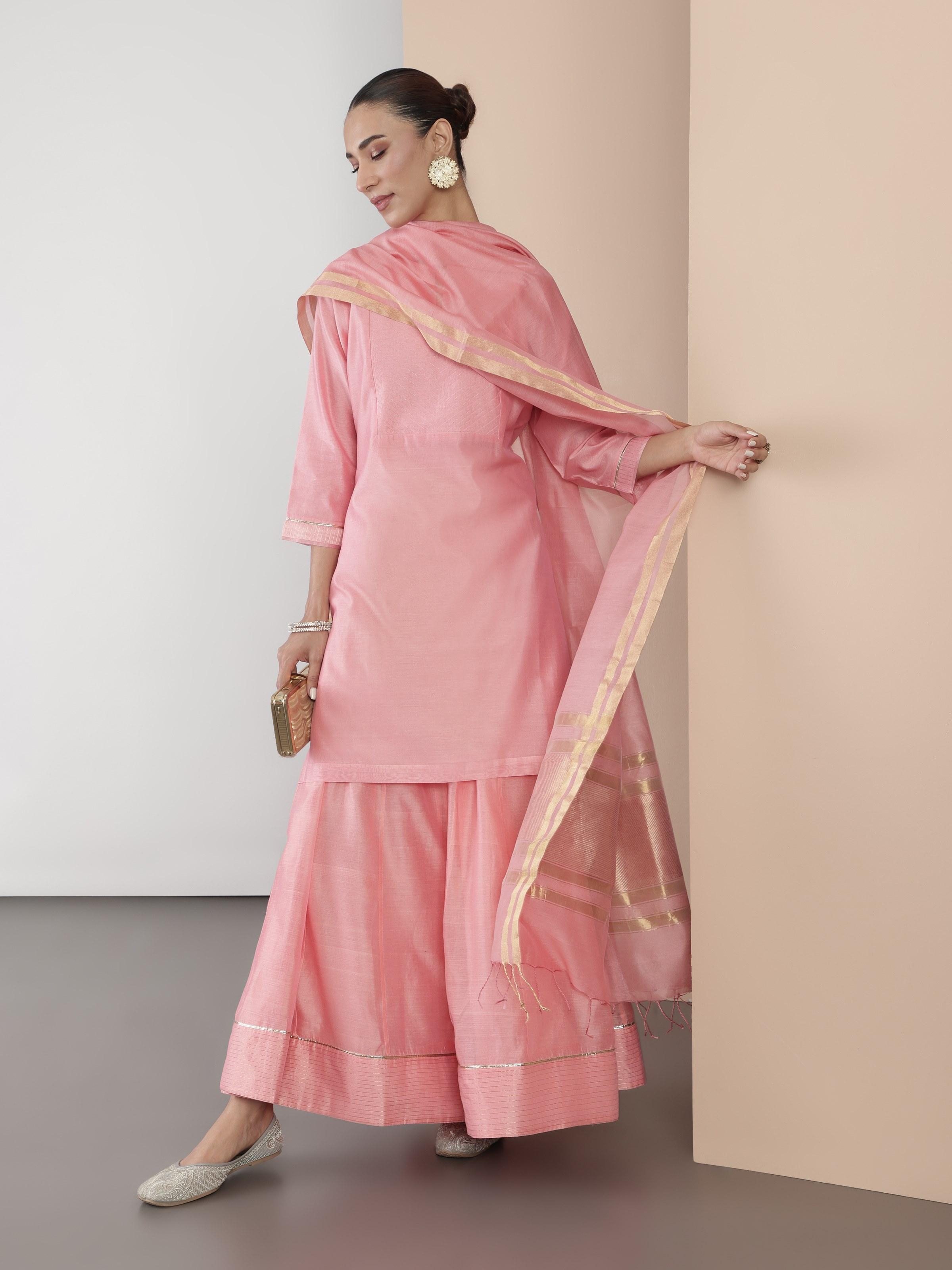 Lifestyle shot of pink cotton silk Chanderi tunic worn with casual styling.